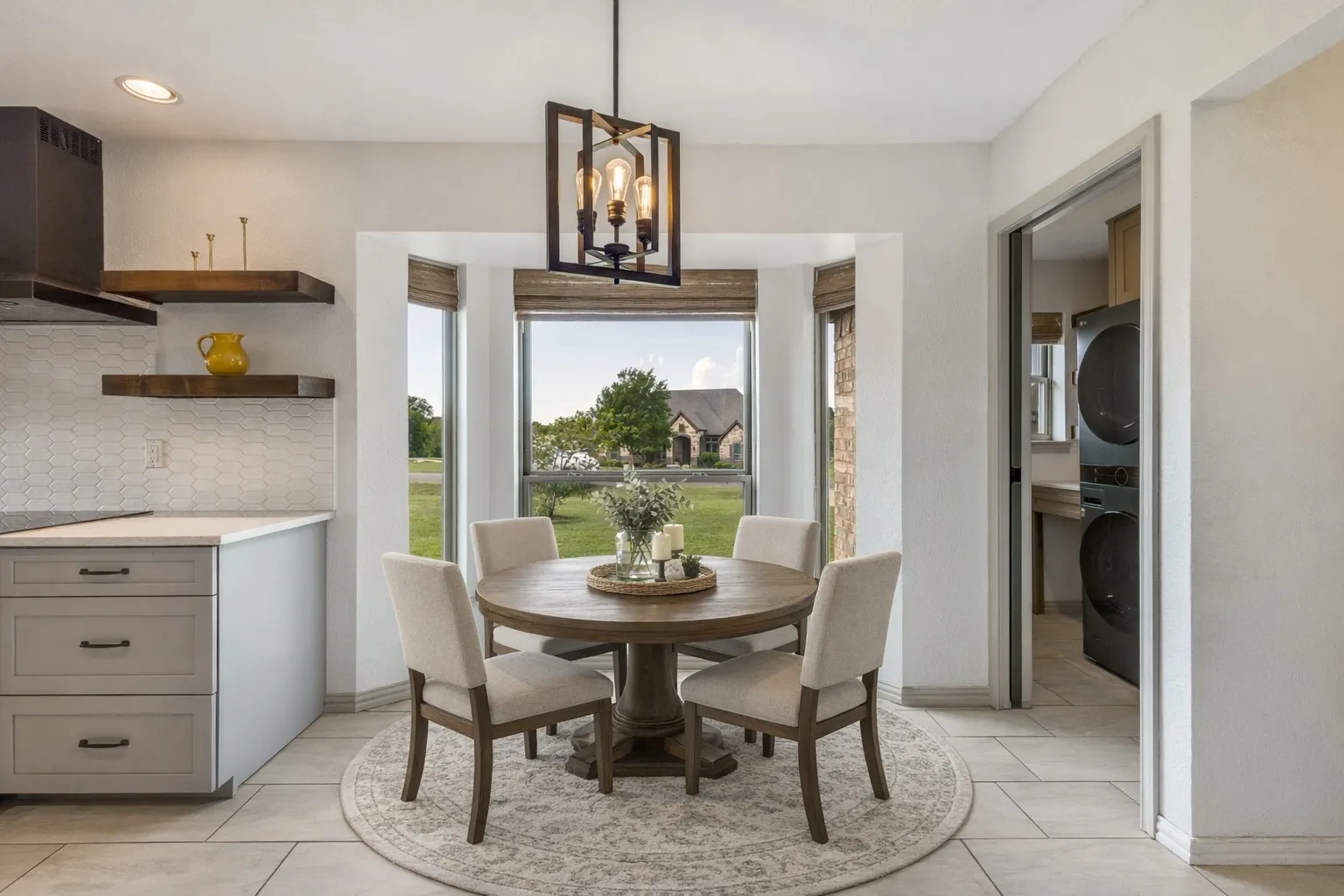 This inviting breakfast nook features a bay window, offering views of the exterior