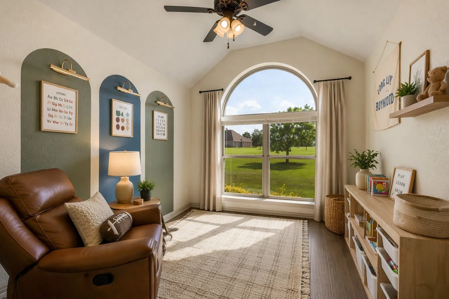 This inviting room features a vaulted ceiling, a large arched window providing outdoor views, and a ceiling fan
