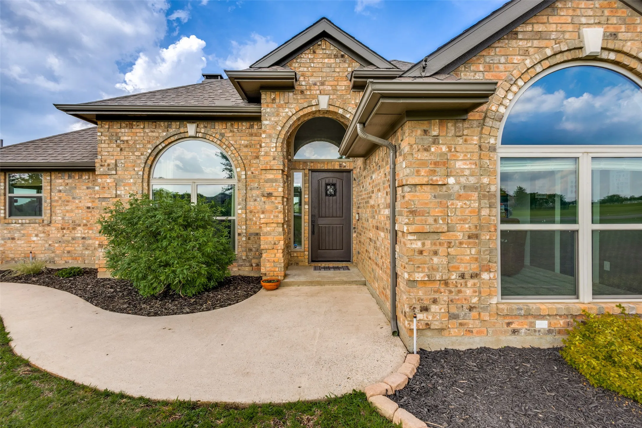 The property features a brick exterior with arched windows and an arched entryway