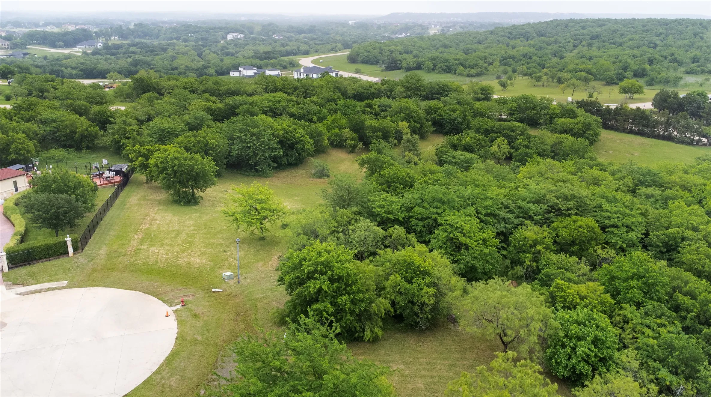 Expansive lot offering significant tree coverage and a gentle slope