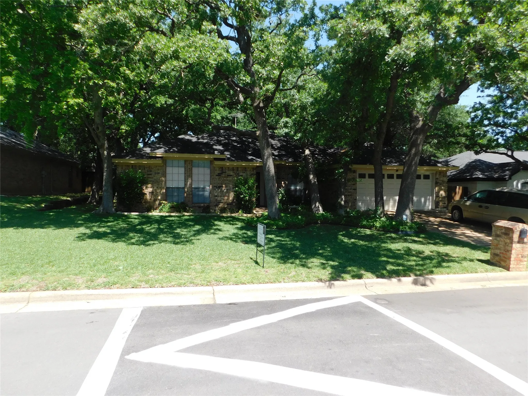 The property features a brick exterior, a two-car garage, and a well-maintained lawn