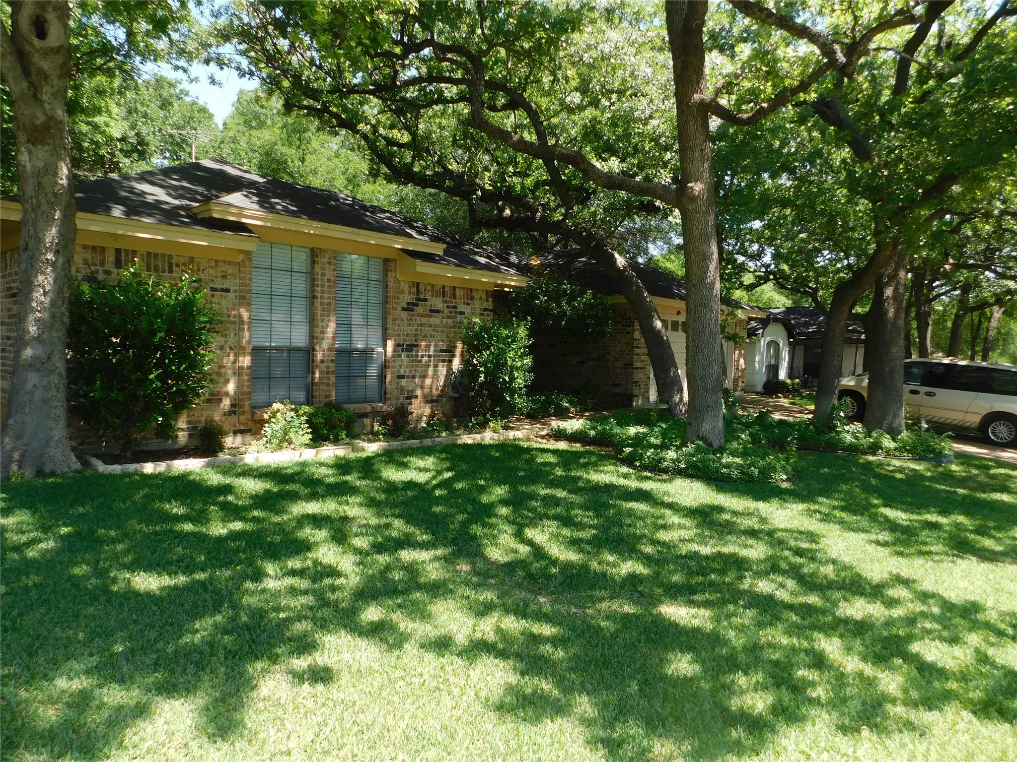 This property features a brick exterior with a dark roof and large windows