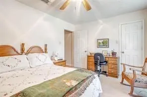 This room features light-colored walls and carpeted flooring, providing a neutral canvas