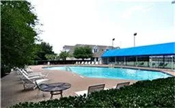 Community swimming pool with a surrounding paved deck