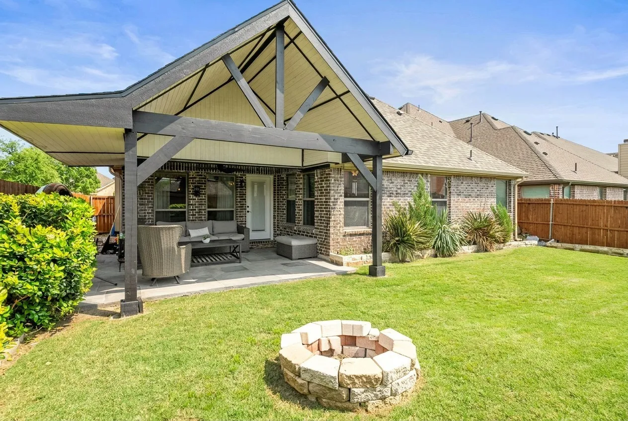 Back patio with quality covered pergola, spacious grass area and firepit.