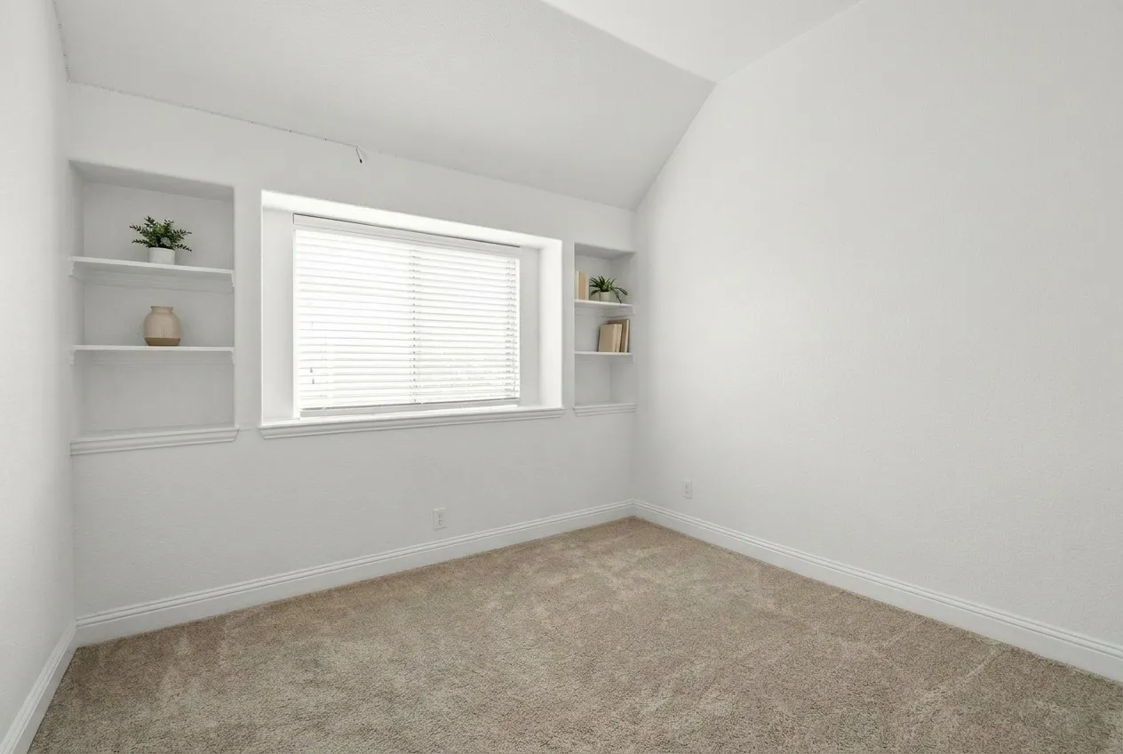 Secondary bedroom on first level - note the built in shelving.