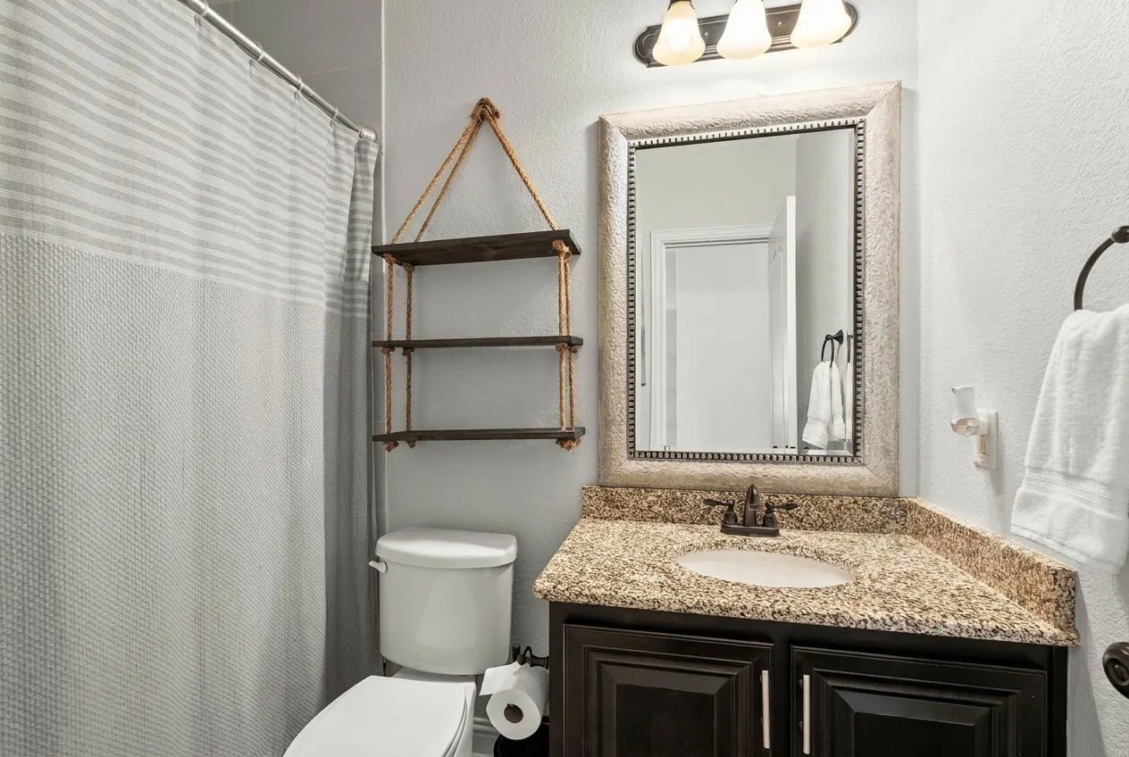 Full bath on first level servicing bedrooms and guests.