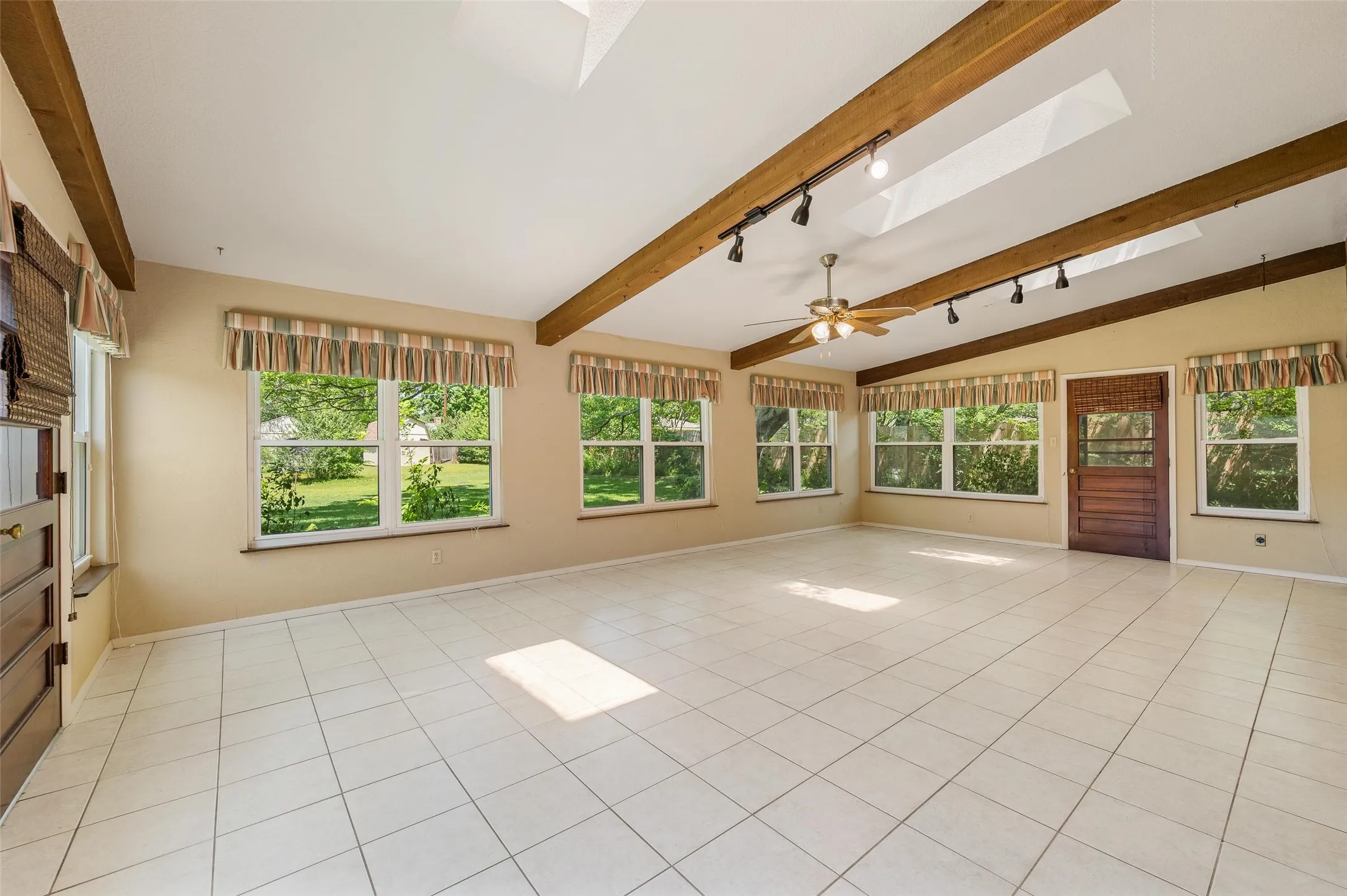Wall of windows look out to the lush backyard.