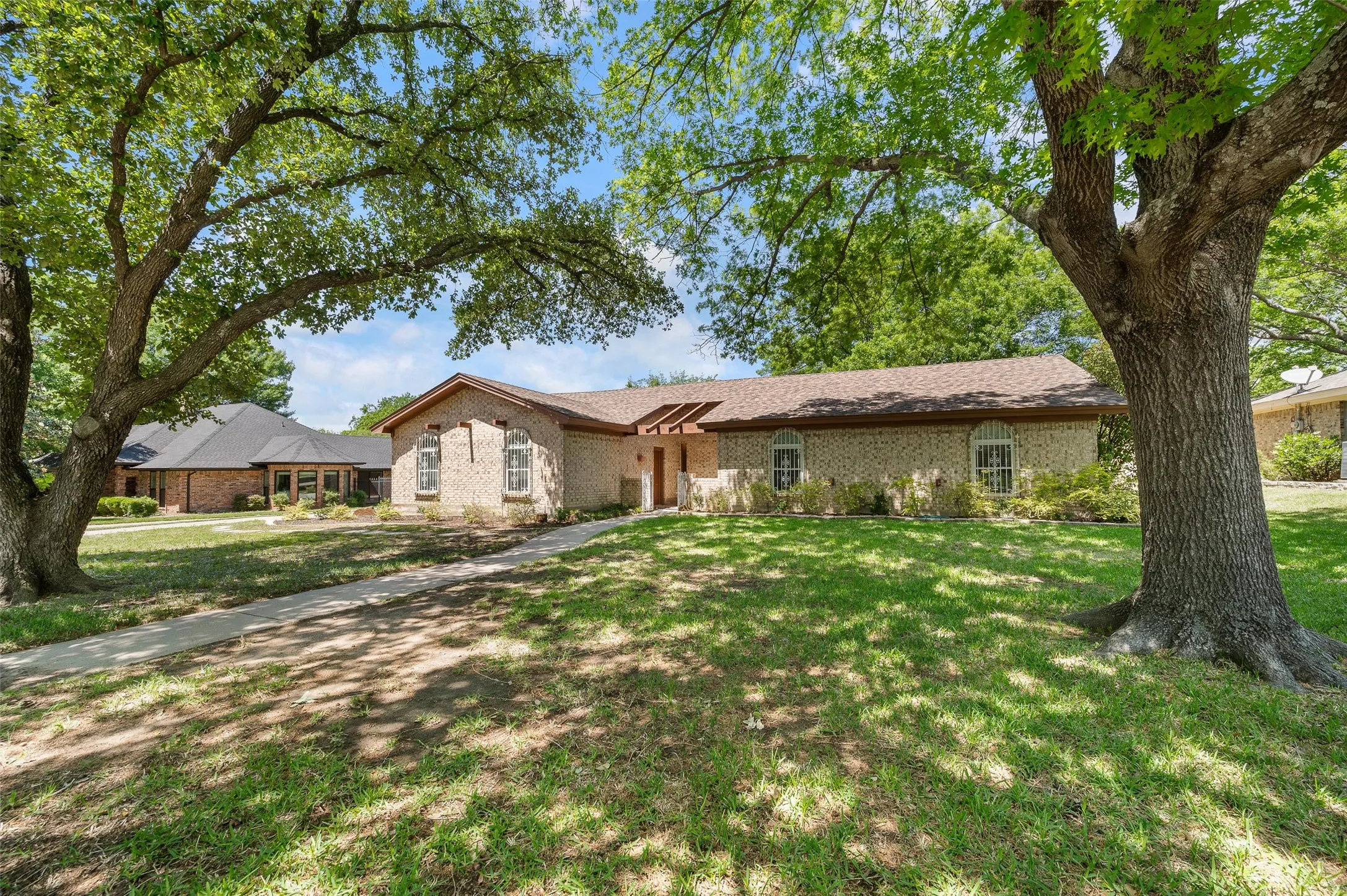 Beautiful mature shade trees compliment this lovely home.