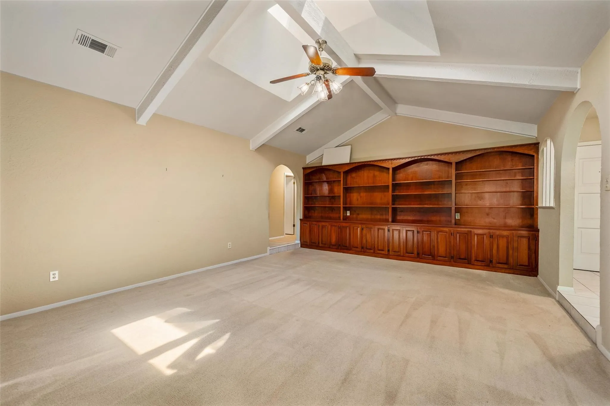 Wall of built in cabinets and shelves.