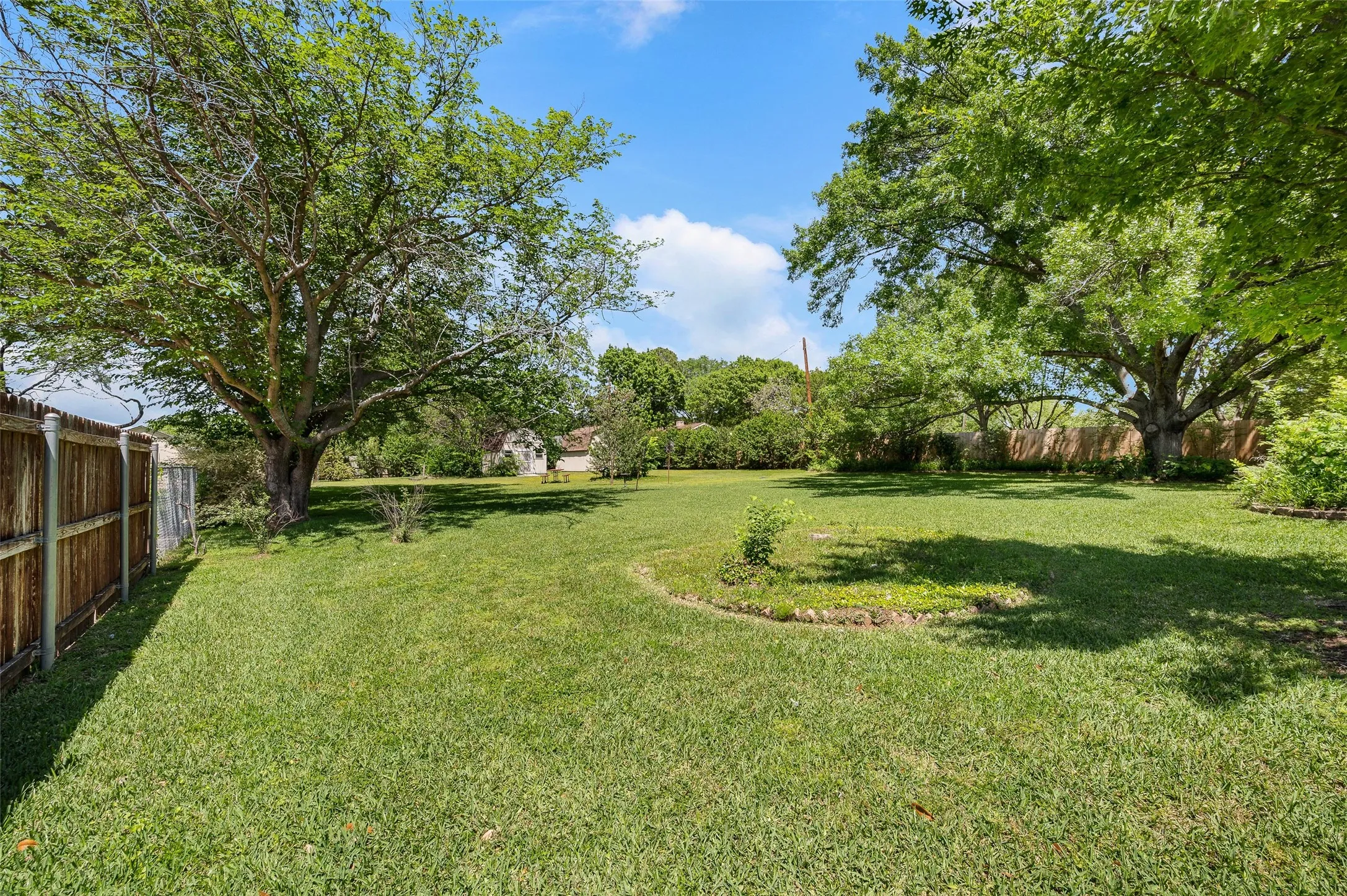 Huge grassy backyard with 2 large storage sheds.