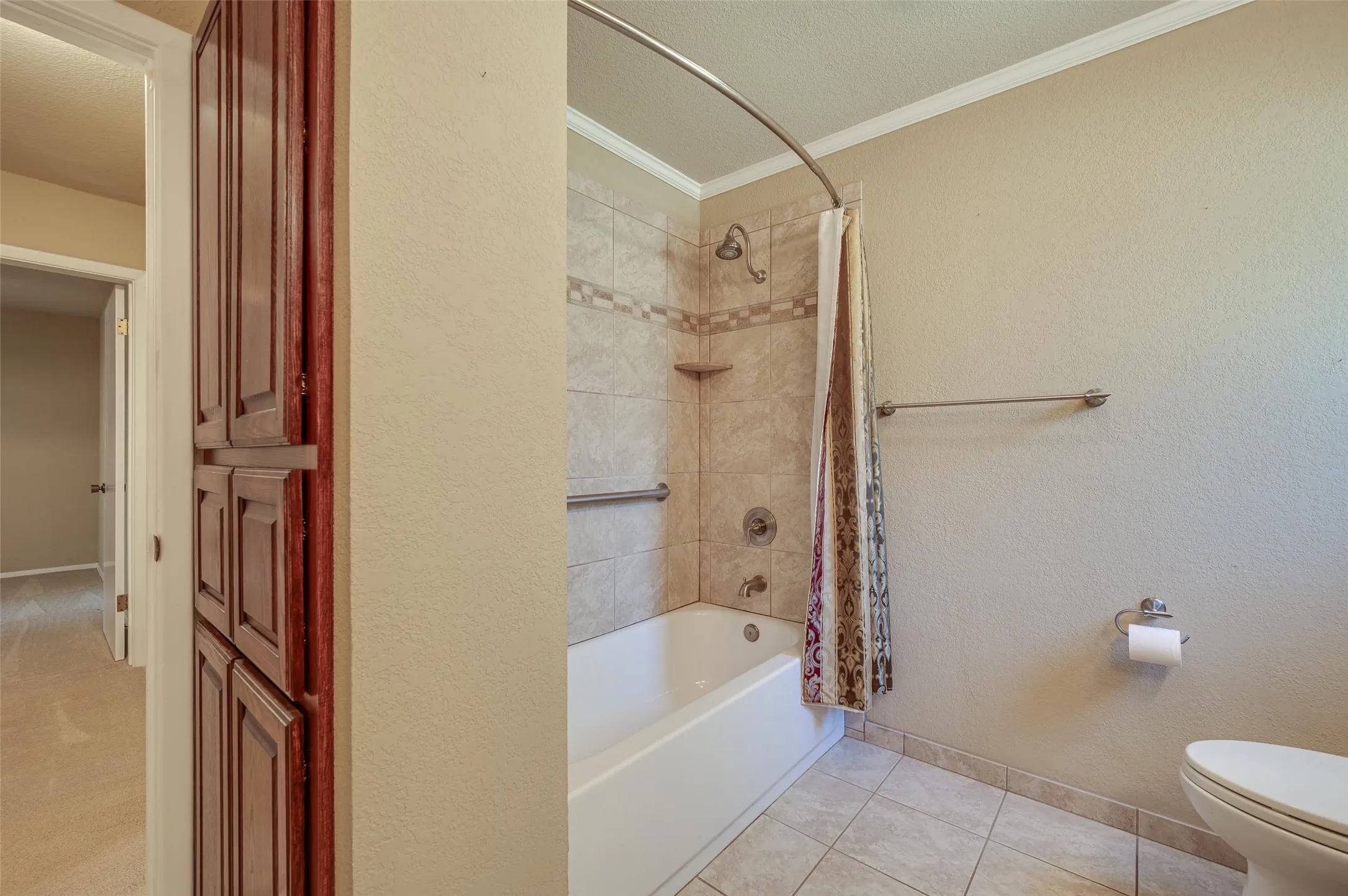 Extra storage cabinet and stunning tub shower in 2nd bathroom.