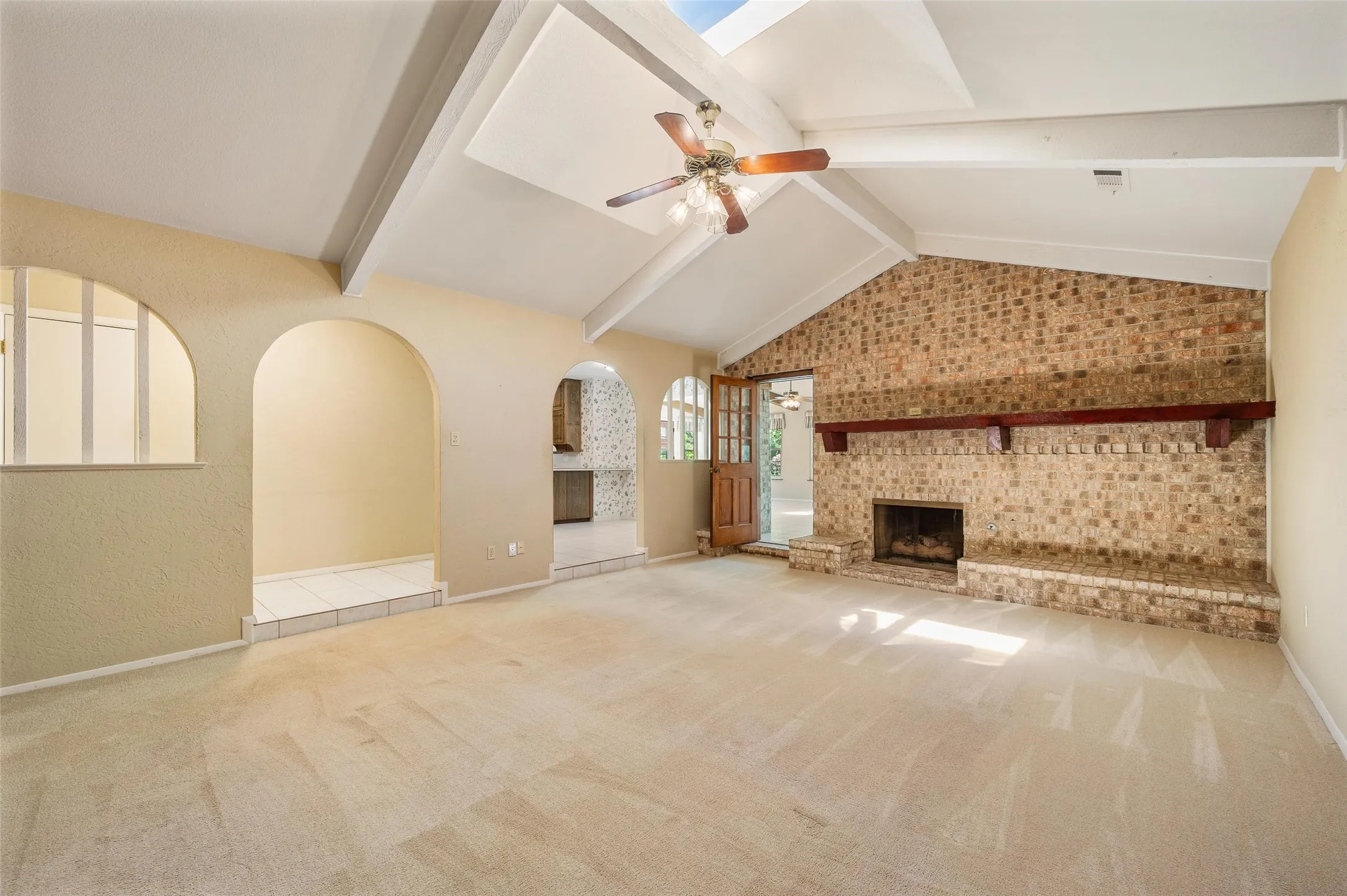 Eye catching gas log fireplace with gorgeous wood mantle.