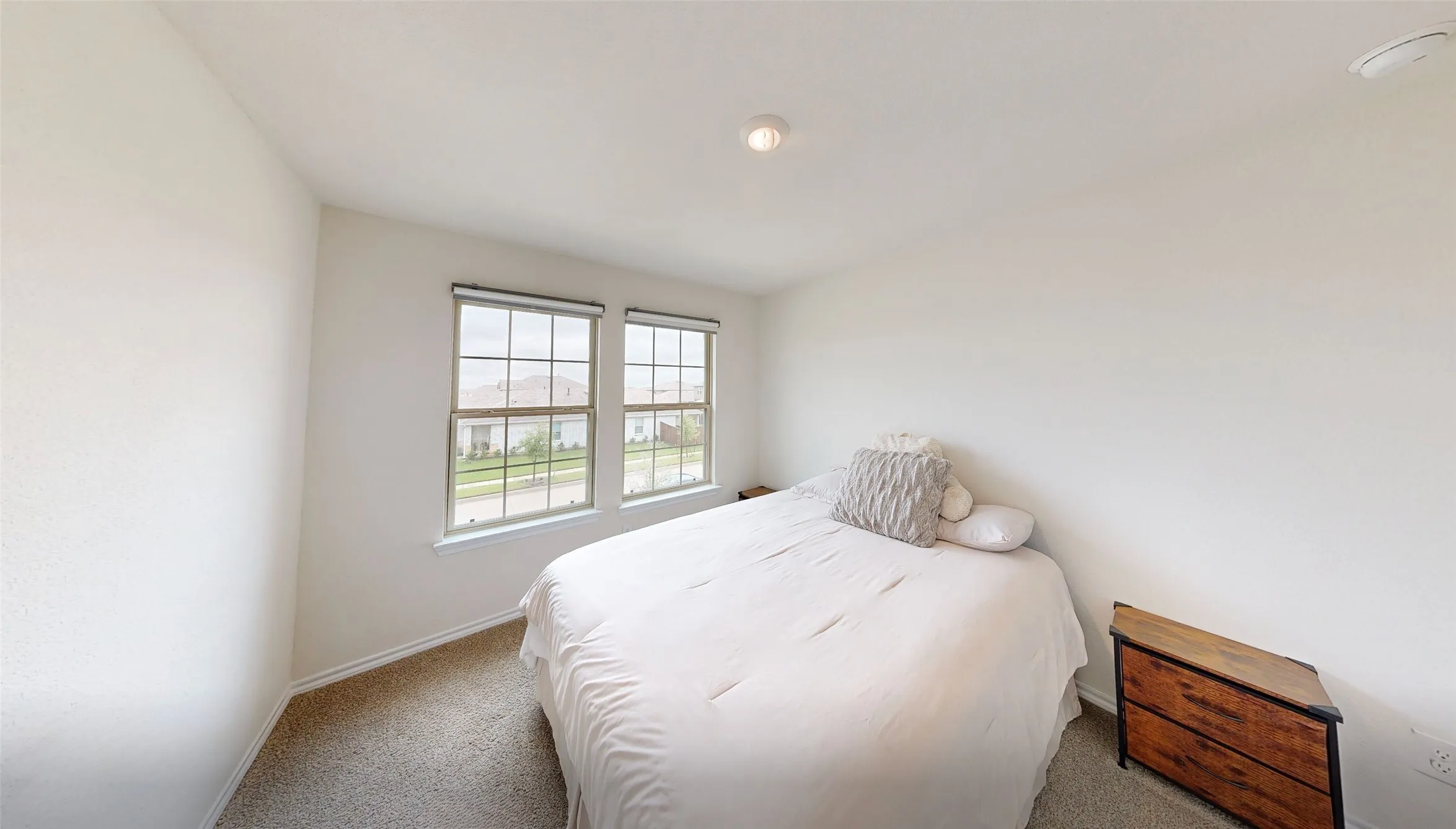 Bedroom featuring neutral carpeting and light-colored walls