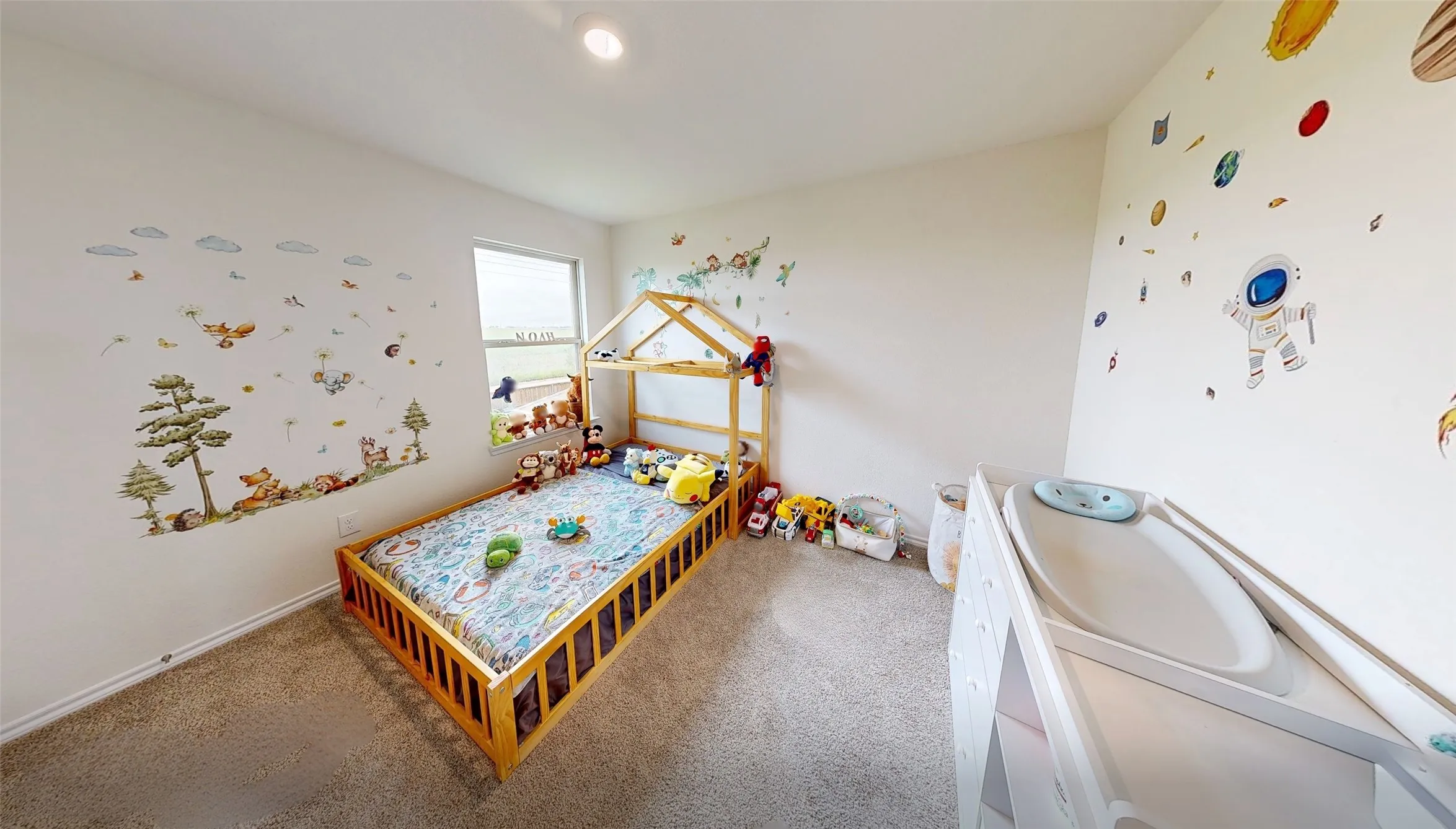 Bedroom featuring light-toned carpeting, a single window, and recessed ceiling lighting