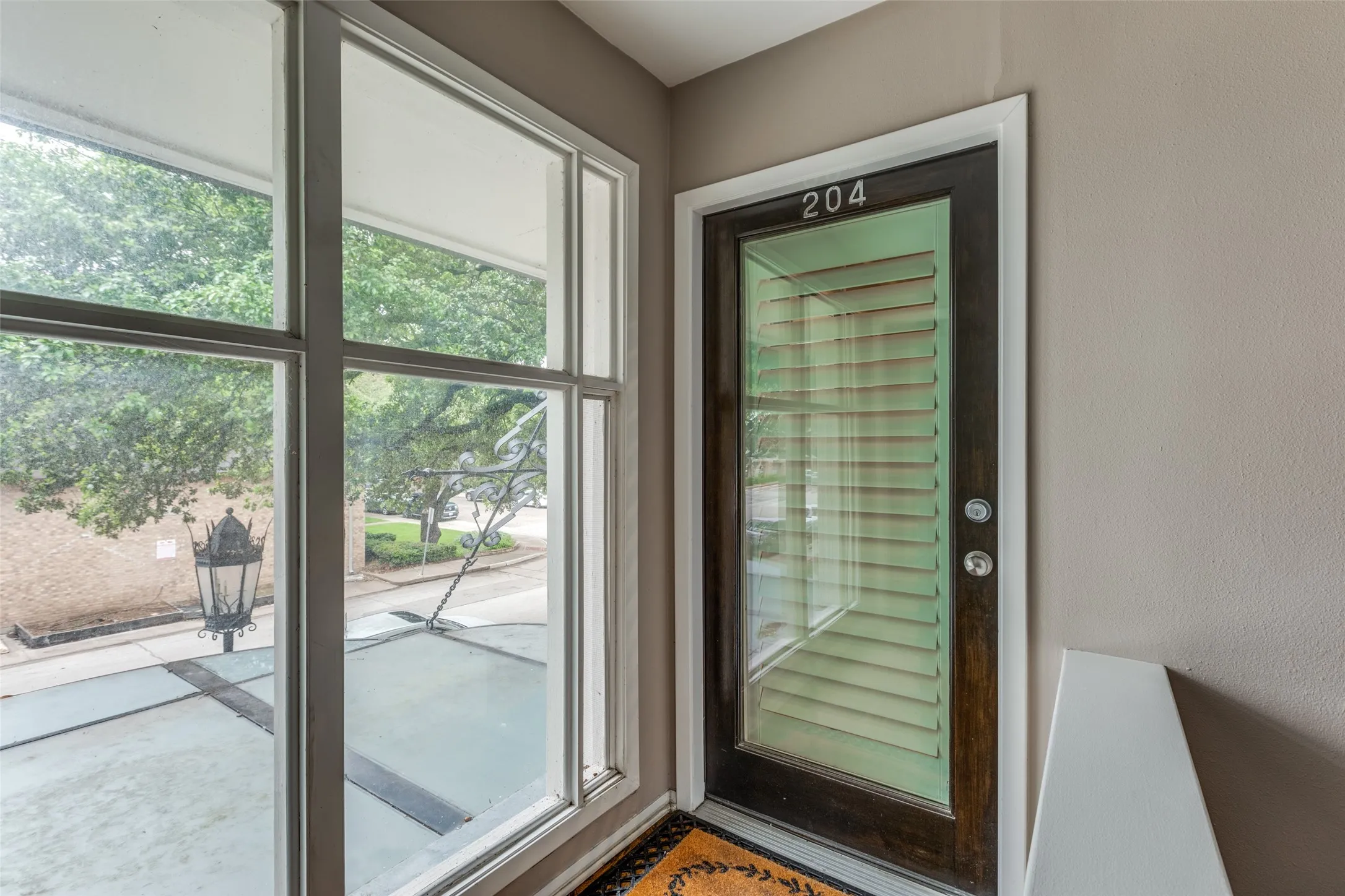 Enter into this fabulous upstairs, tree top, corner unit condo through this light filled door.