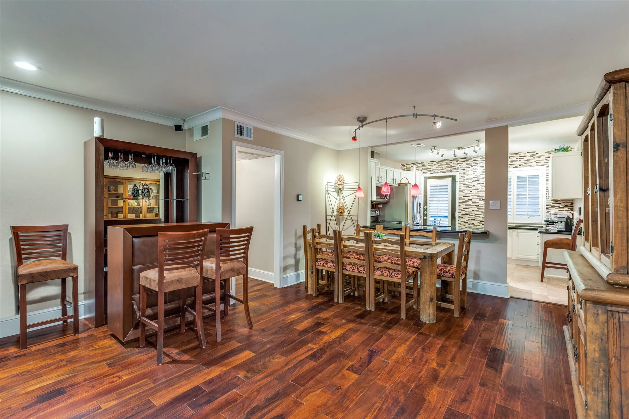 Dining area with plenty of space for a big family table and recessed bar area.