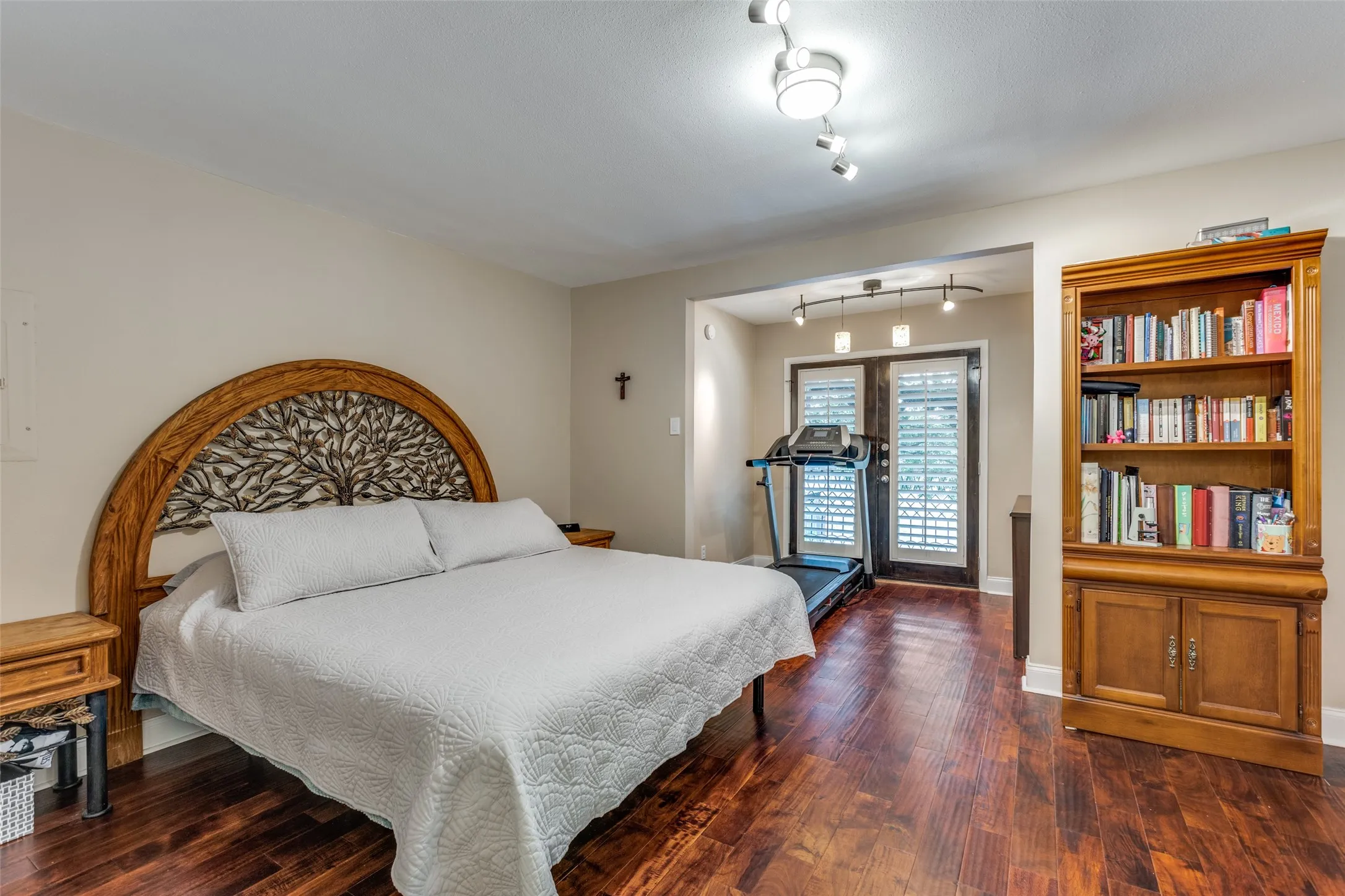 Spacious primary bedroom has french doors, flex area for office or workout area, ensuite bath and walk in closet.