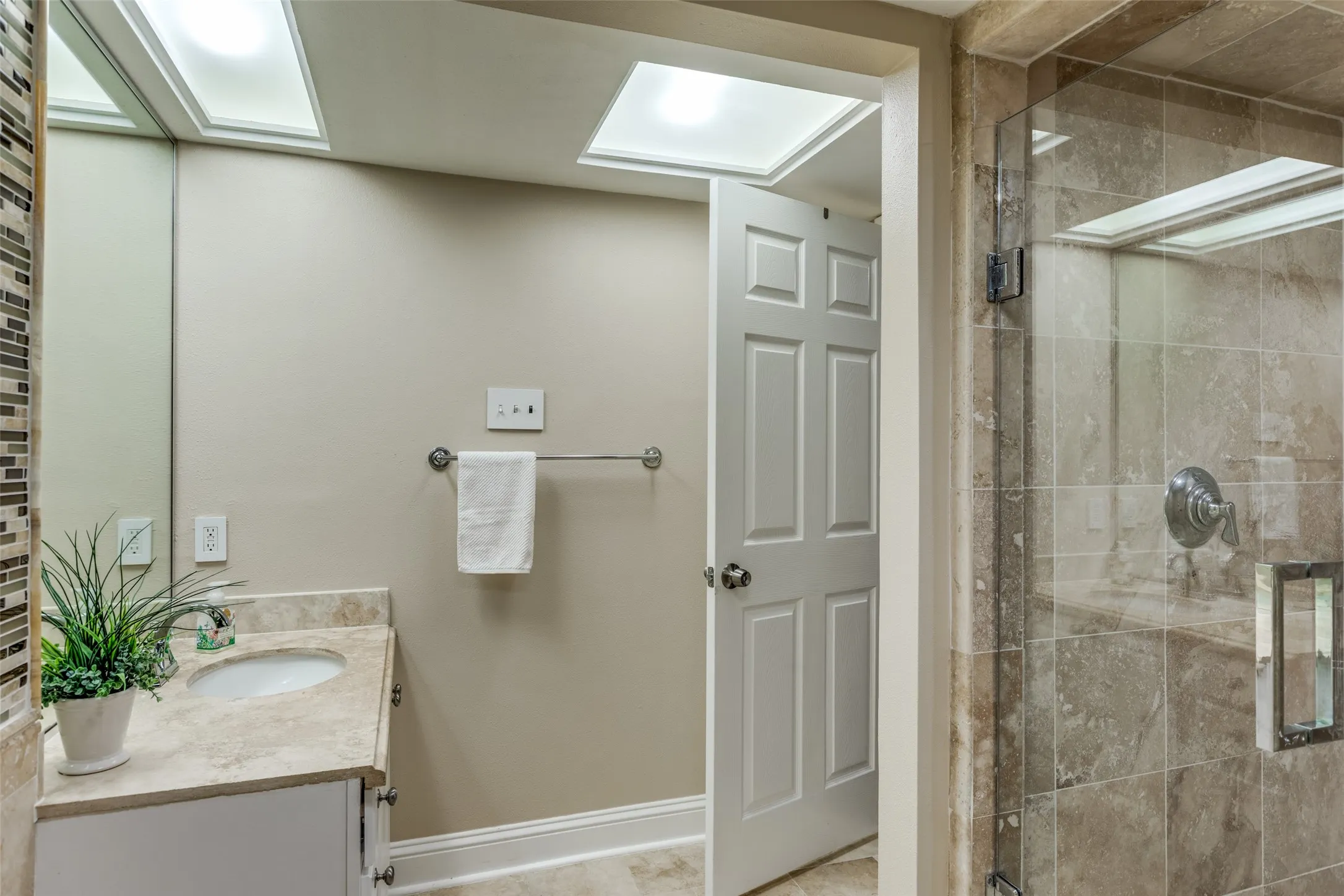 Primary bath has granite countertops and large walk in shower.
