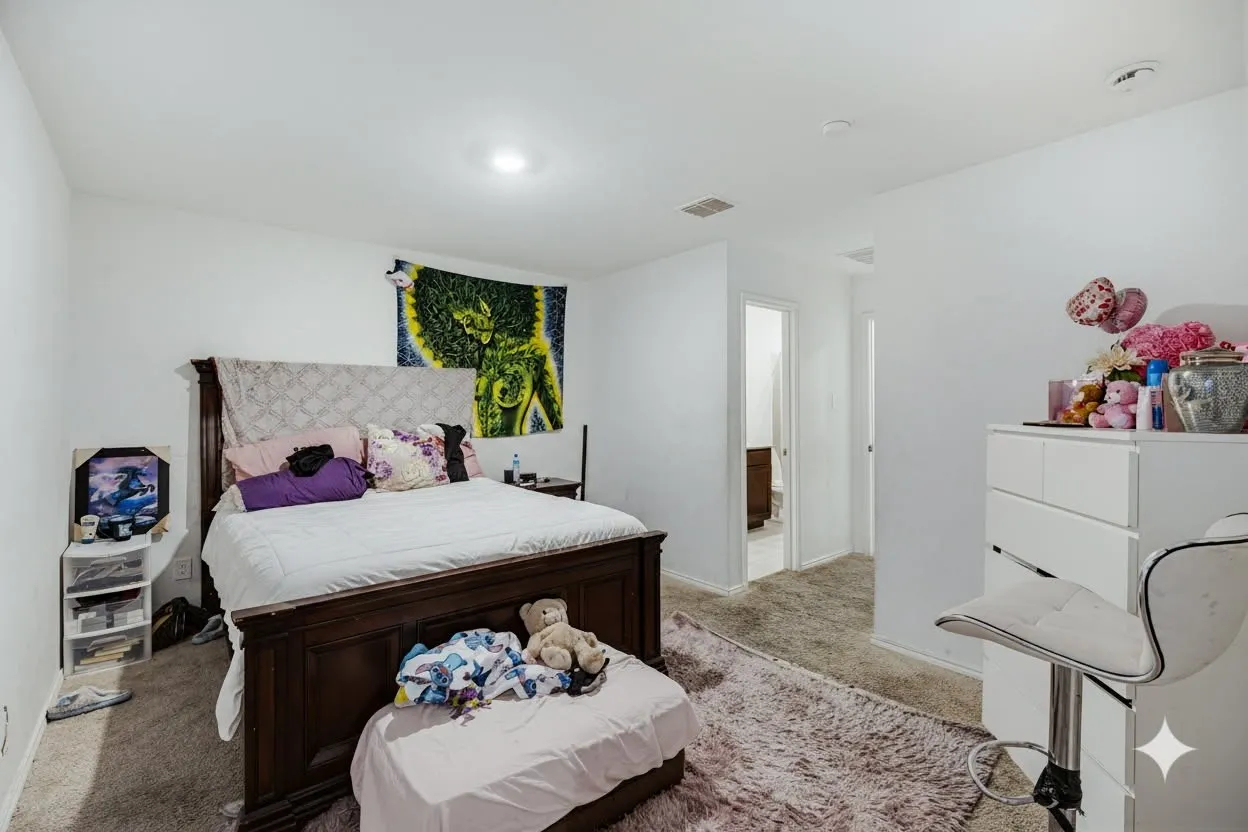 Bedroom featuring light-colored walls and carpet, with a recessed ceiling light.  Virtually Staged