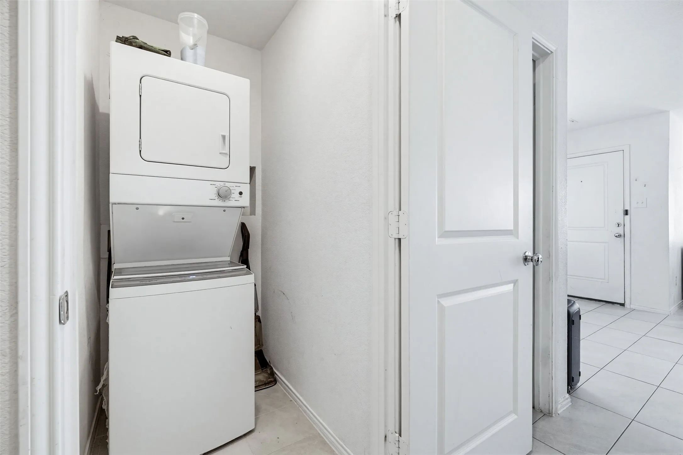 Dedicated utility area featuring a stacked washer and dryer, providing essential functionality