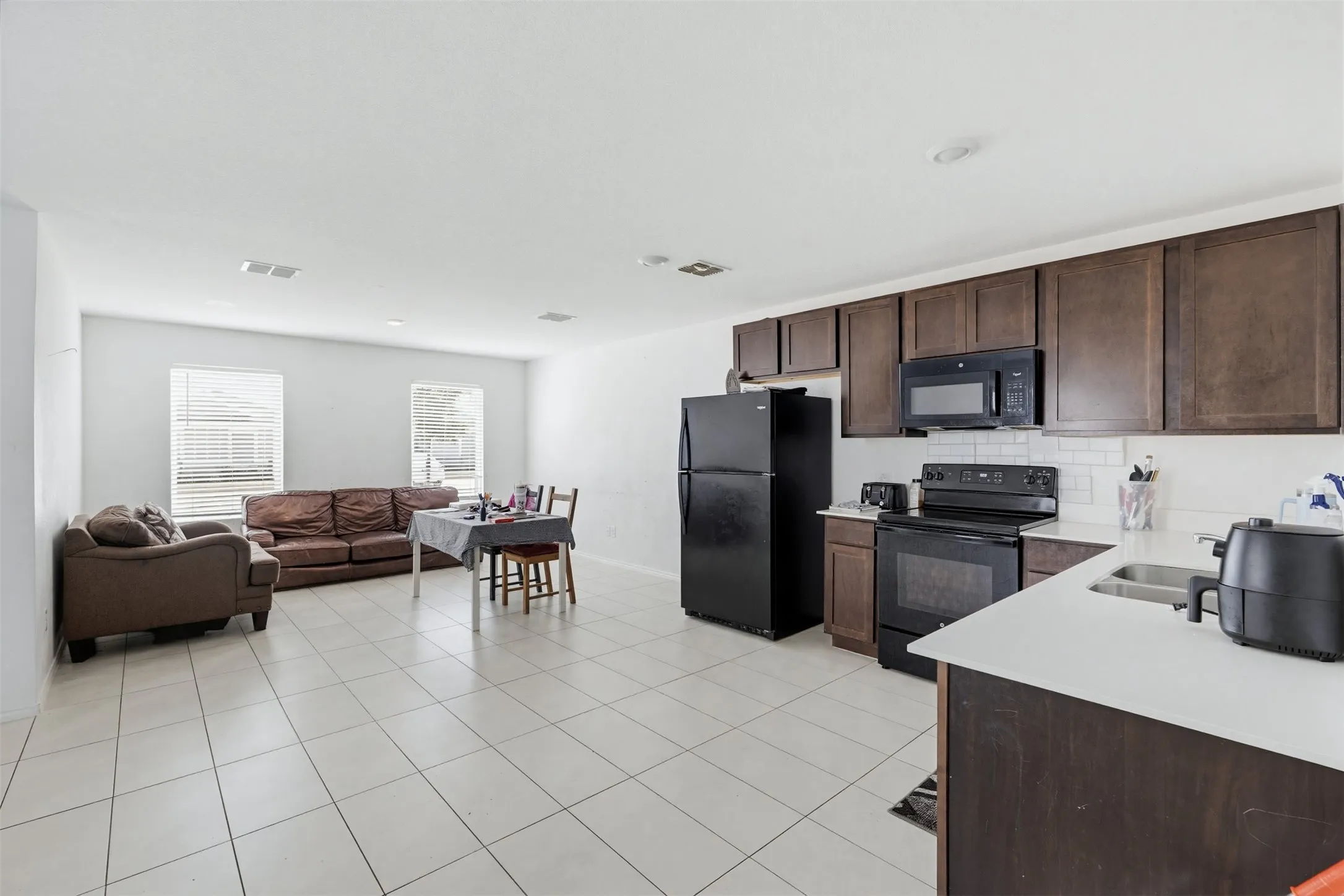 Open concept living area featuring tiled flooring throughout