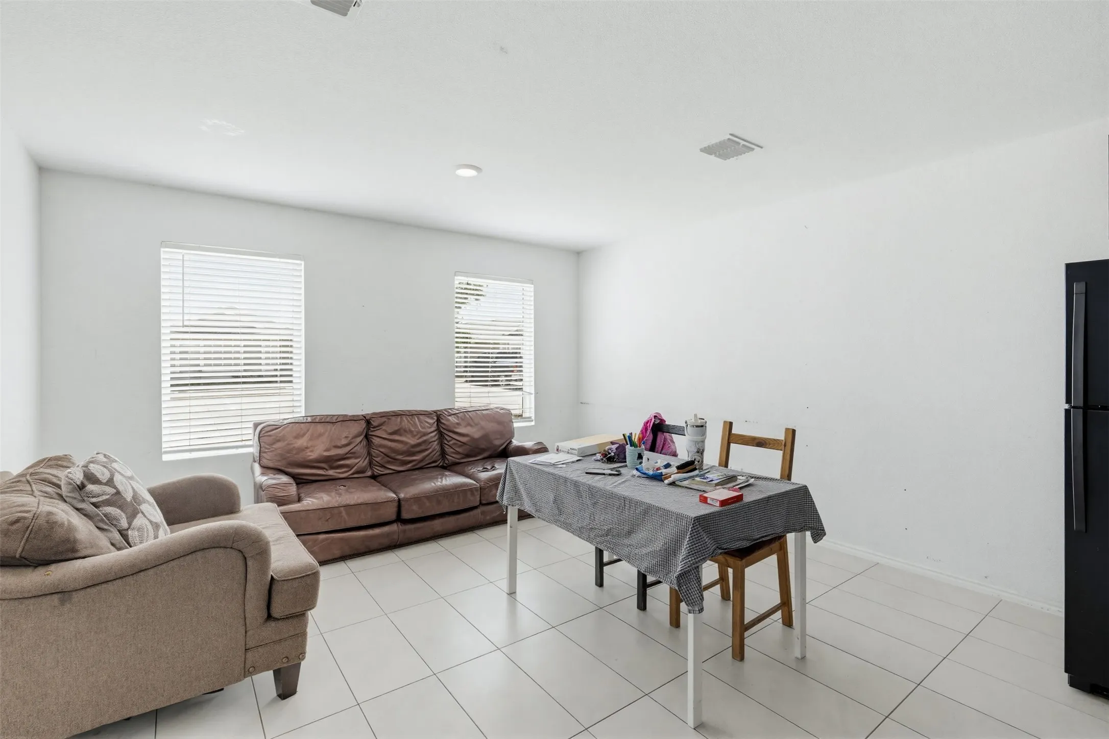 The property features light-colored tiled flooring throughout, complemented by white walls