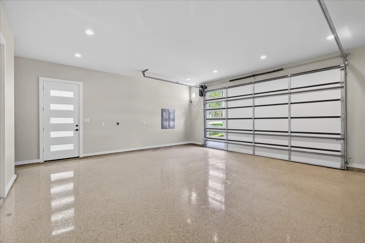 Oversized 2 car garage with apoxy floors to accommodate larger vehicle height.