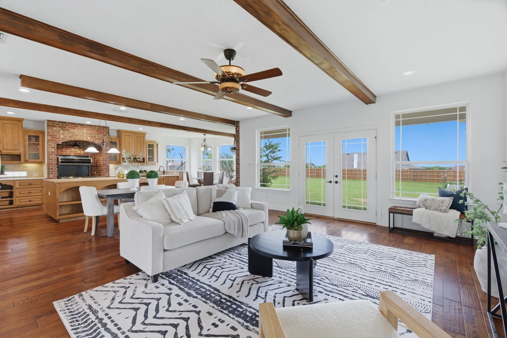 Exposed wood beams, abundant windows and an open connection to the kitchen give the main living room a spacious, inviting feel.