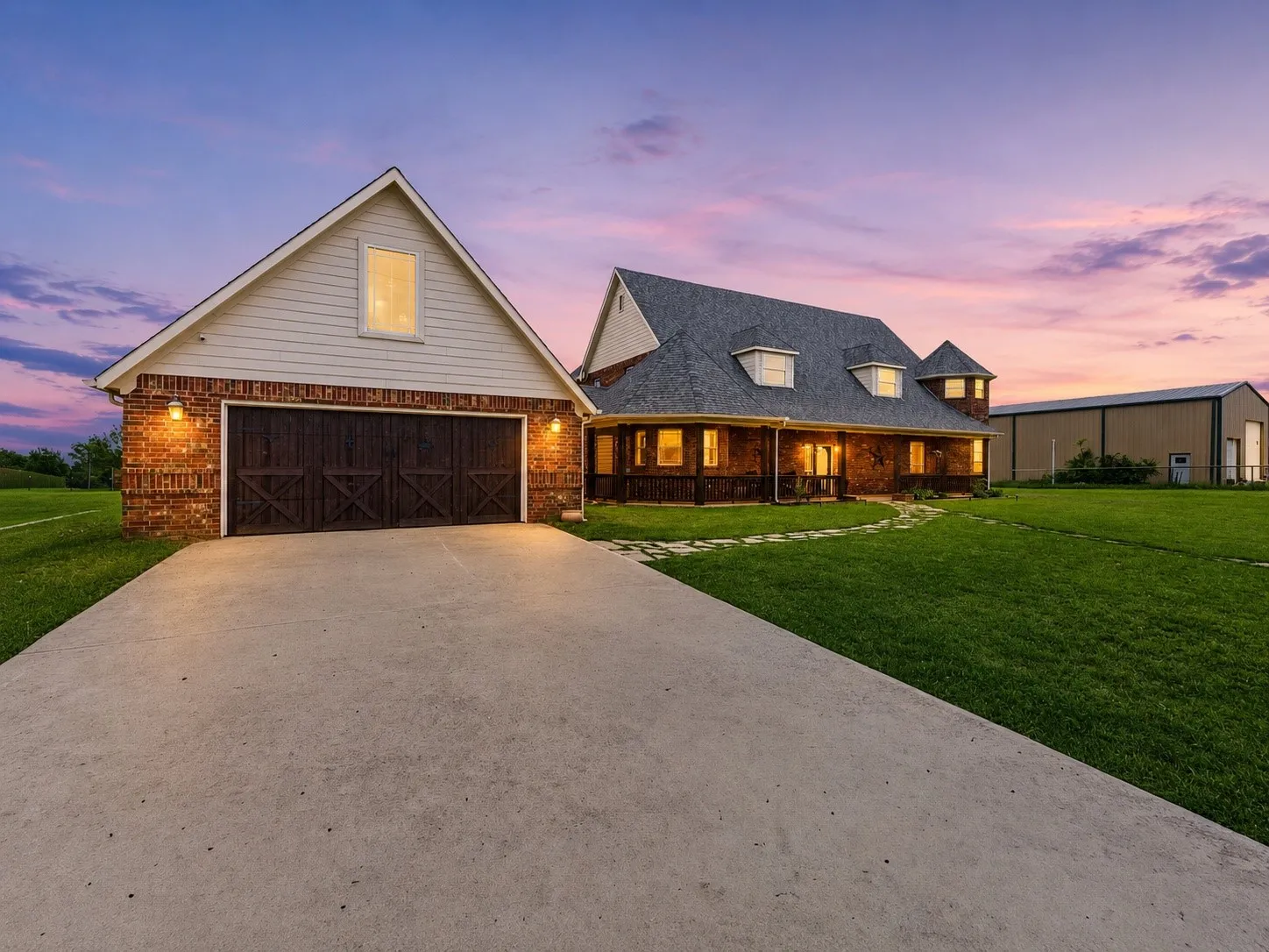 A private gated drive leads to the 3-car garage and spacious brick home at 250 Newfield Ln in Springtown, TX.