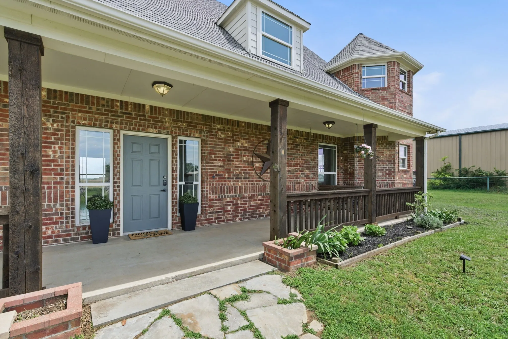 The welcoming covered porch brings classic Texas character to this Springtown home, with brick construction, wood columns and room to sit and stay awhile.