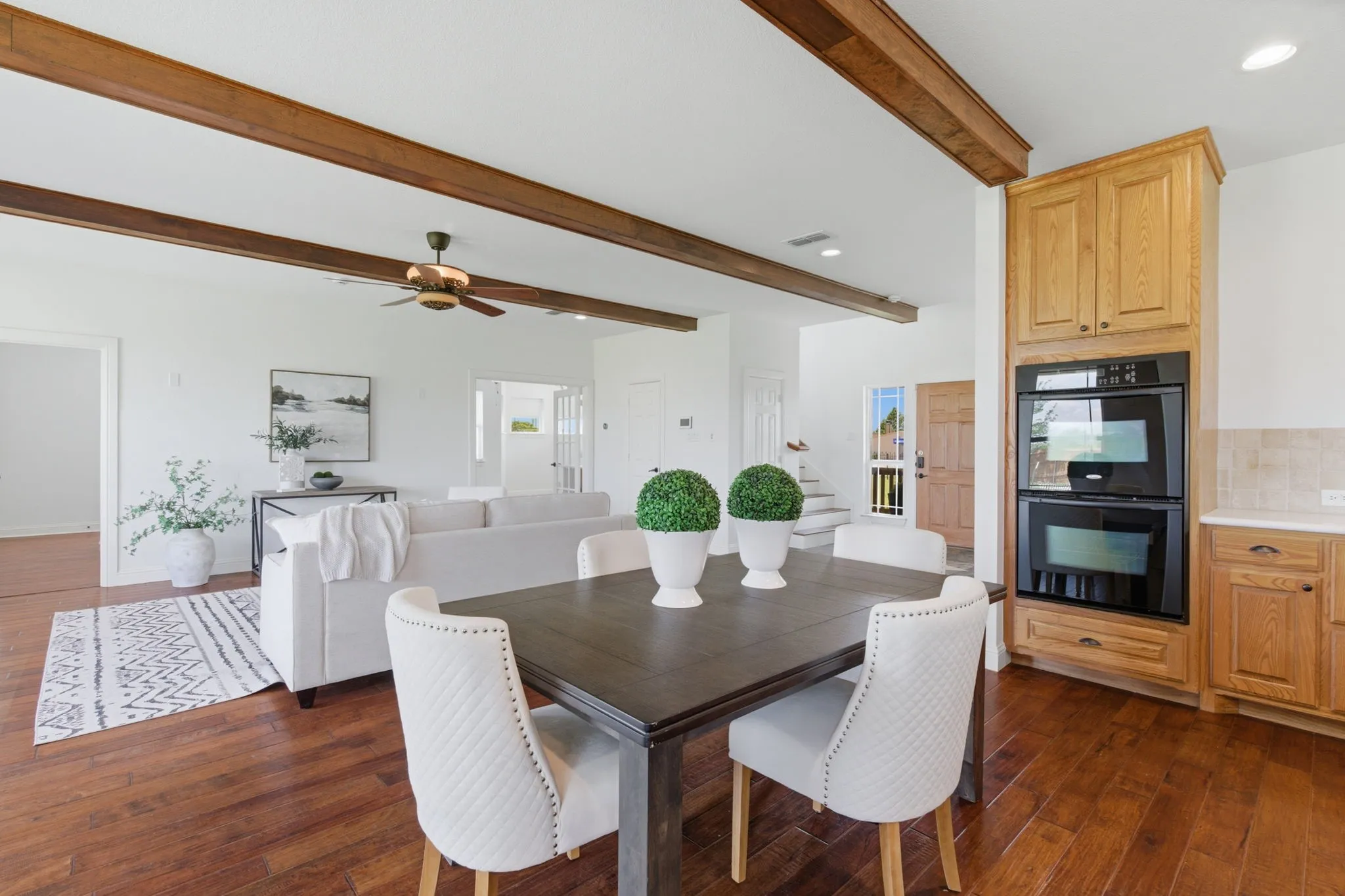 Double ovens, extensive cabinetry and an open view toward the living room add practical function to the kitchen and dining area.