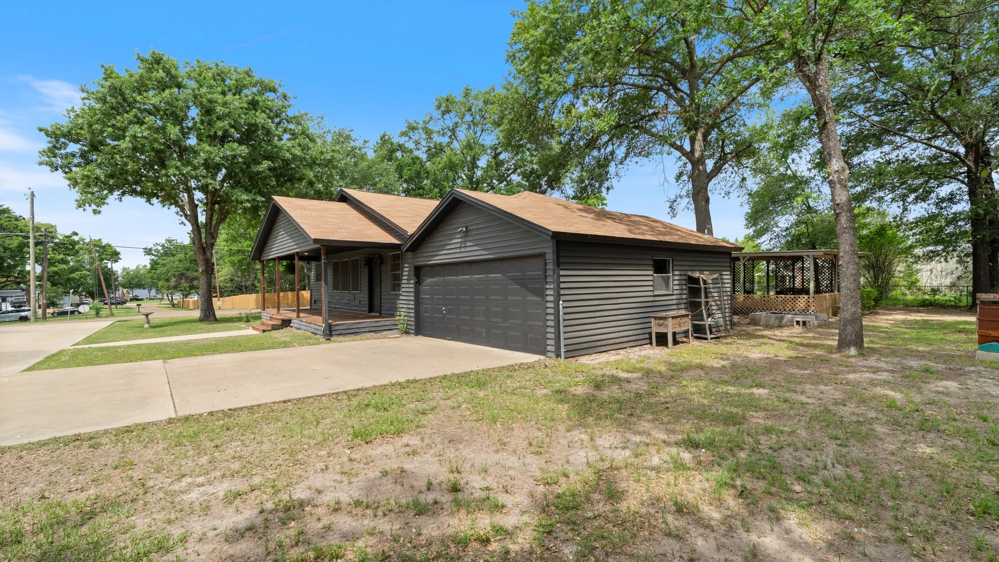 The property features a concrete driveway, a front porch, and an attached garage