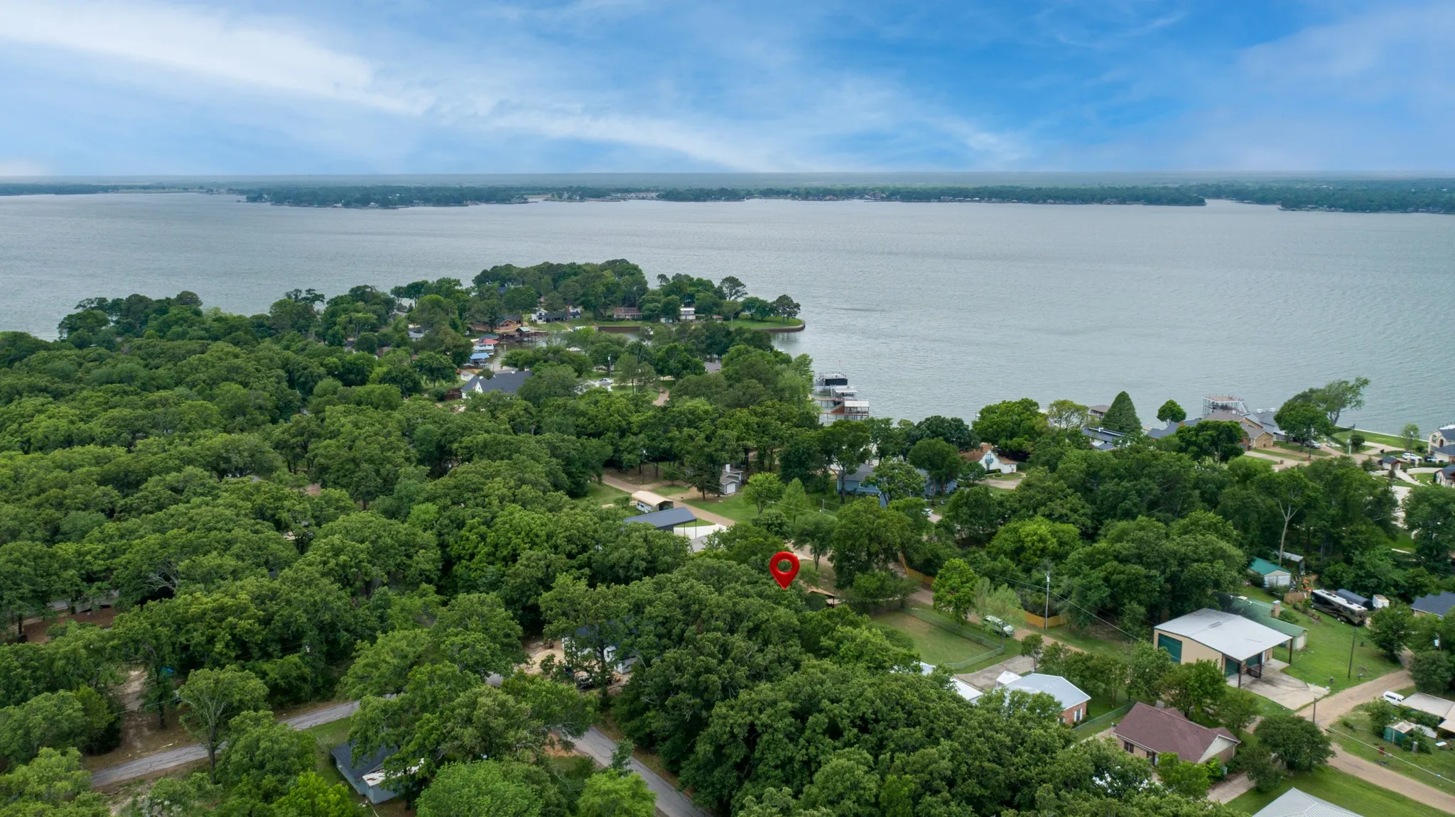 This property is located in a community with extensive tree coverage and features a prominent lake view