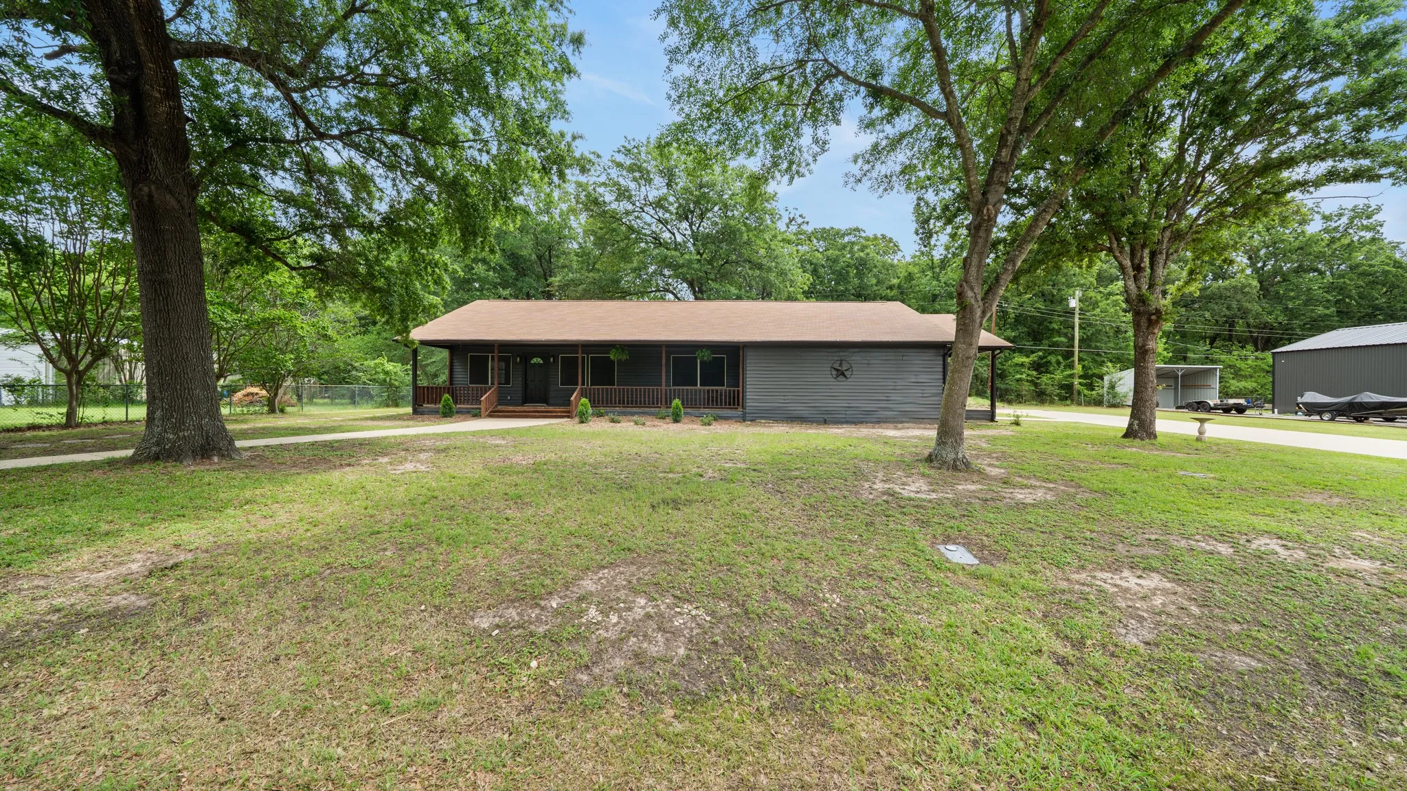 The property features a ranch-style exterior with a covered front porch and a brown roof