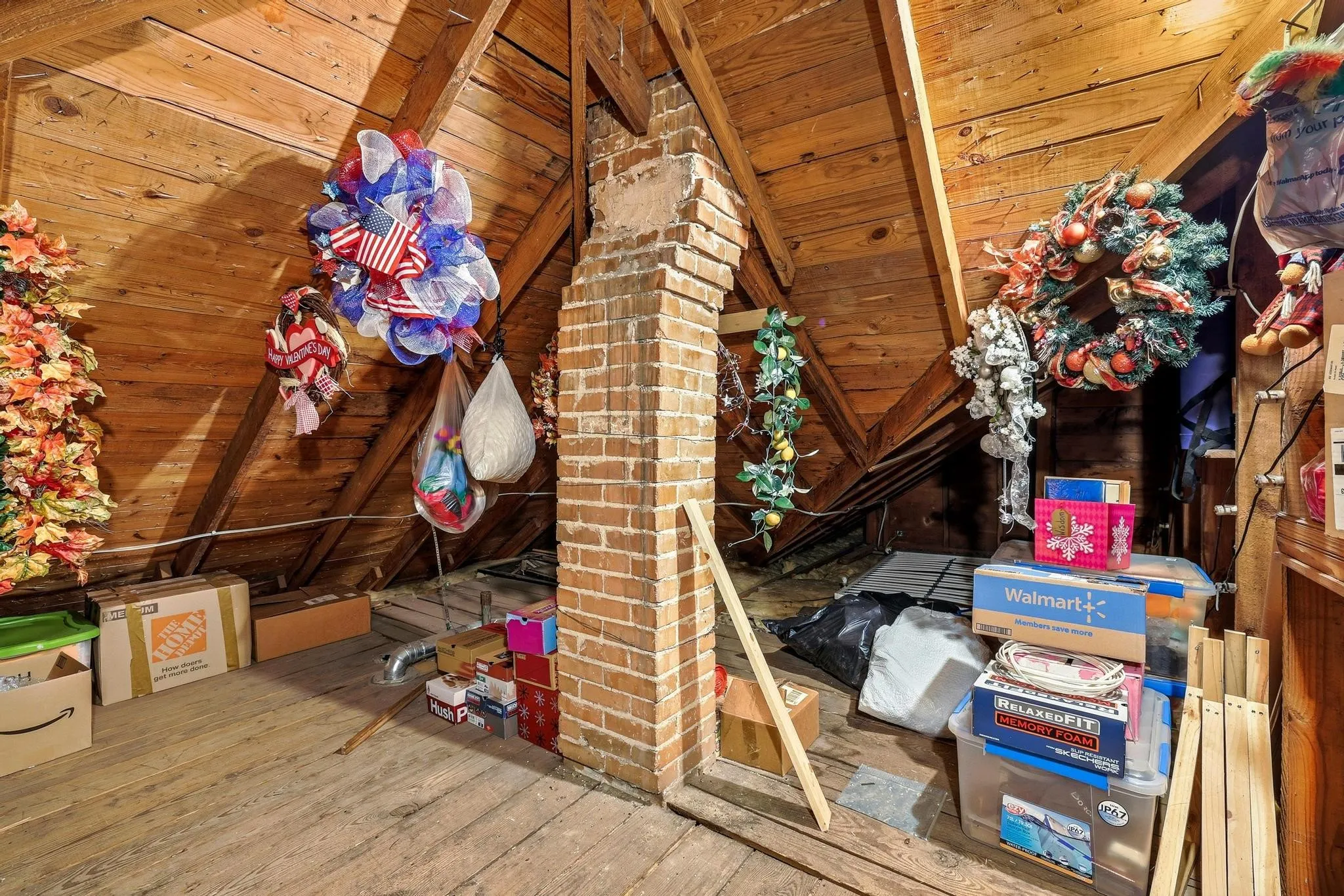 The attic features exposed wood beam ceilings and a brick chimney structure