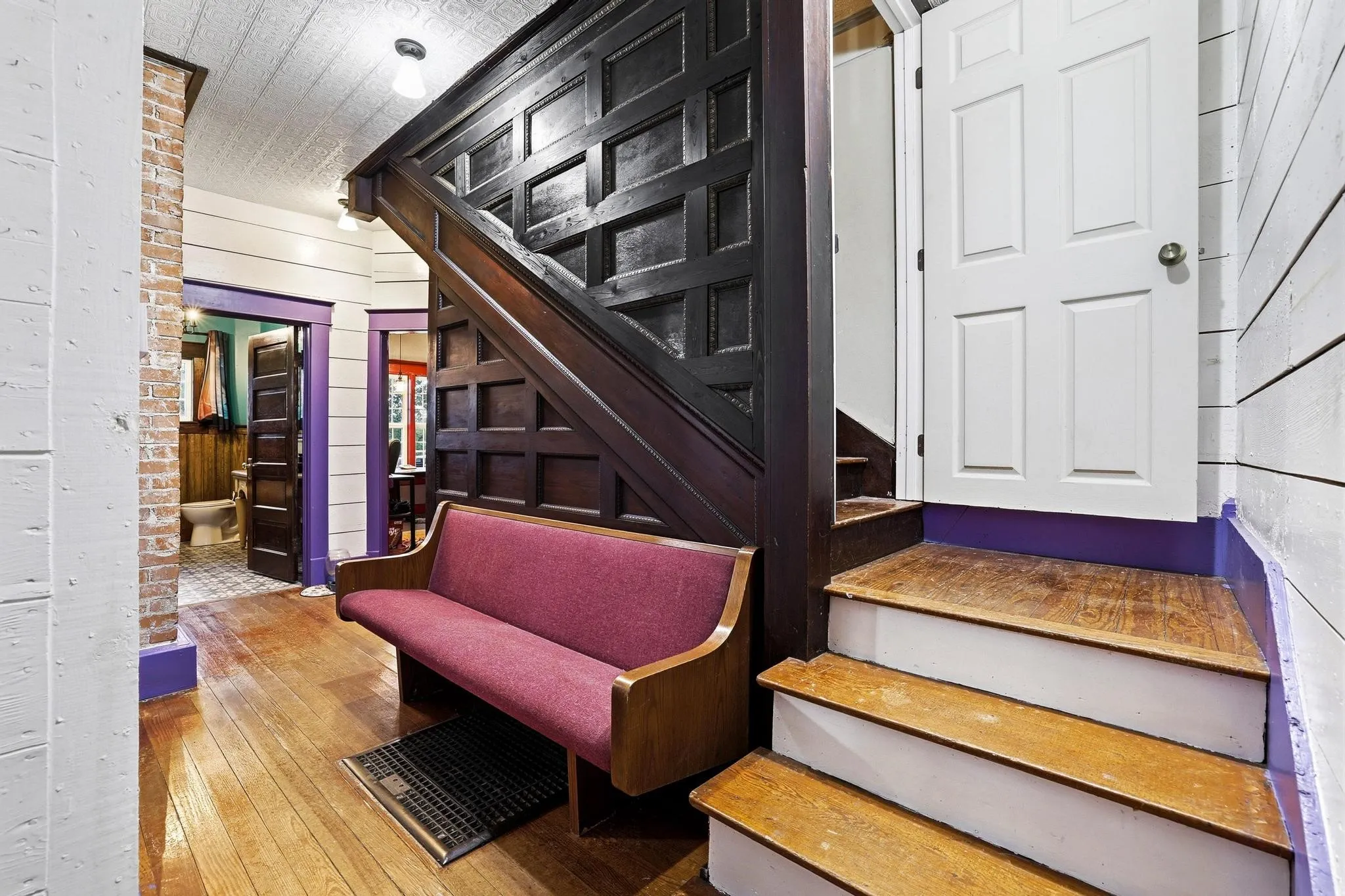 Upstairs landing to stairs has great wood details and a door for privacy.