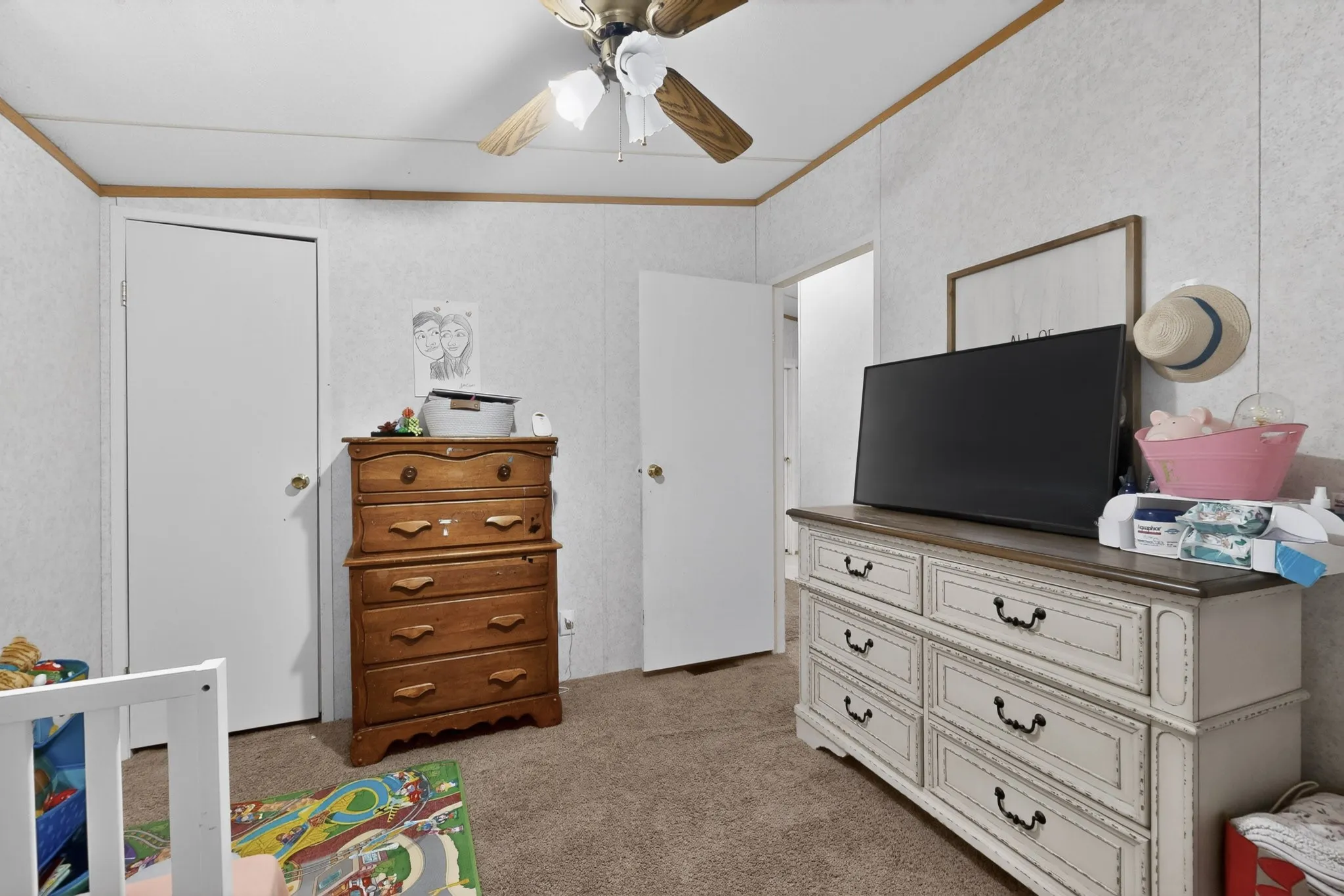 This interior room features carpeted flooring and white walls with wood trim