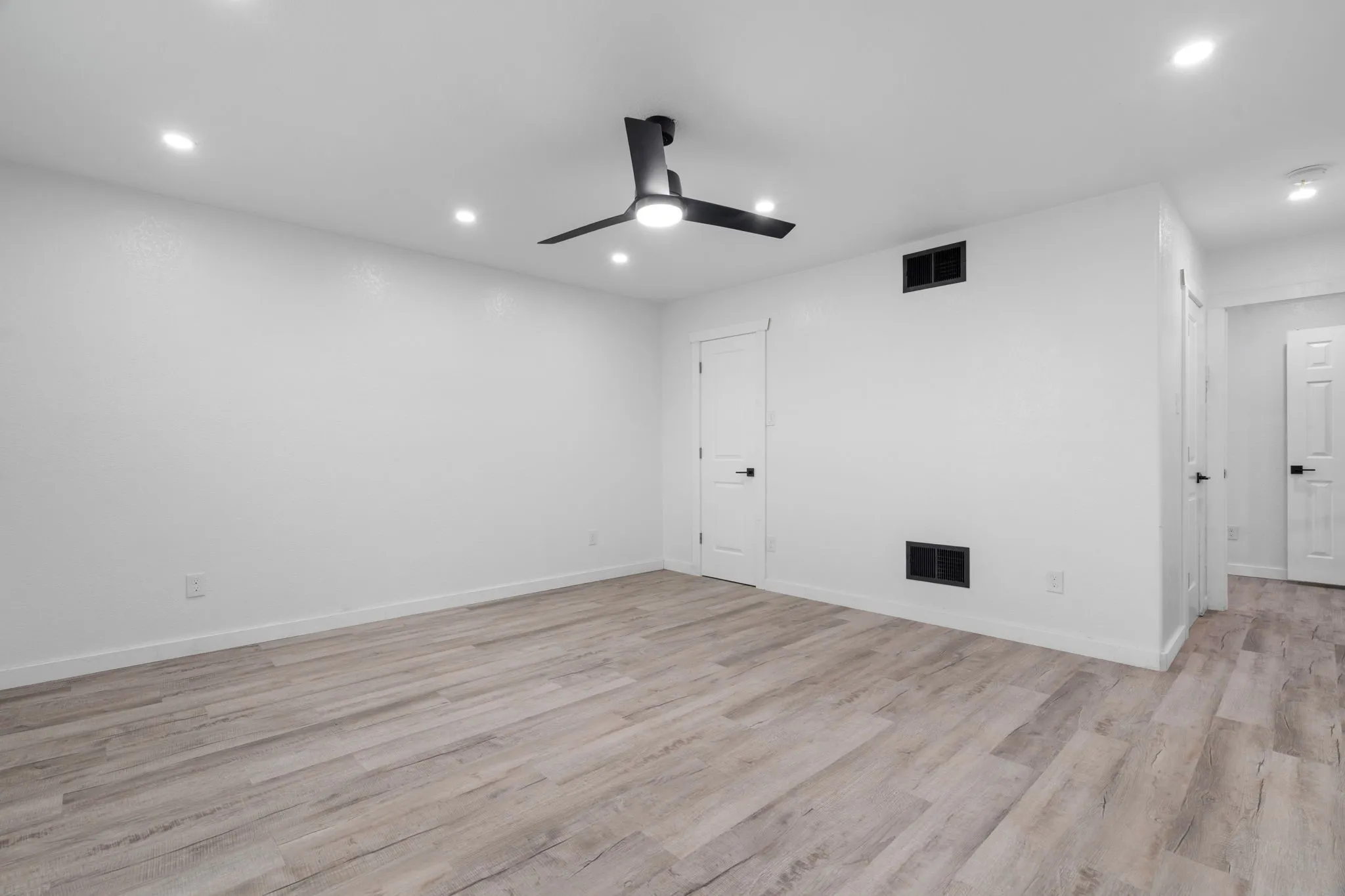 Spacious room featuring wood-finish flooring, recessed lighting, and a Guest Bedroom contemporary ceiling fan