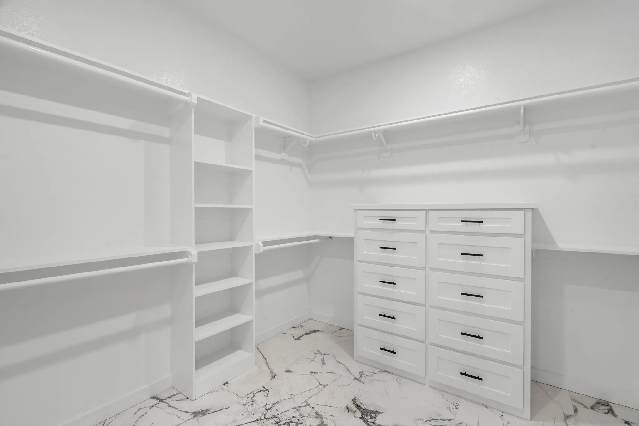 Spacious Primary bedroom featuring large-format tile flooring, a tray ceiling with recessed lighting, and a modern ceiling fan