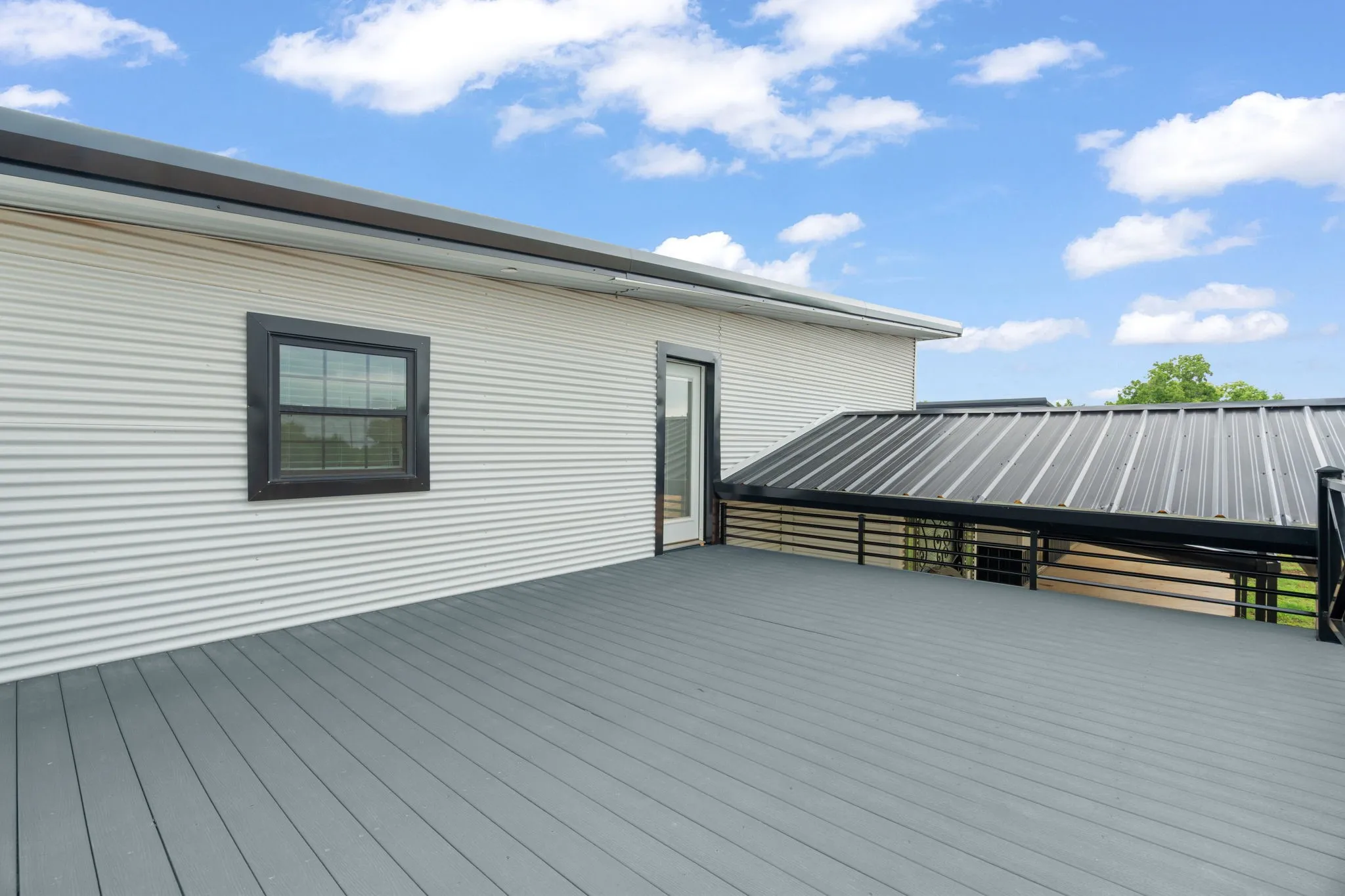 Spacious outdoor deck featuring gray composite decking