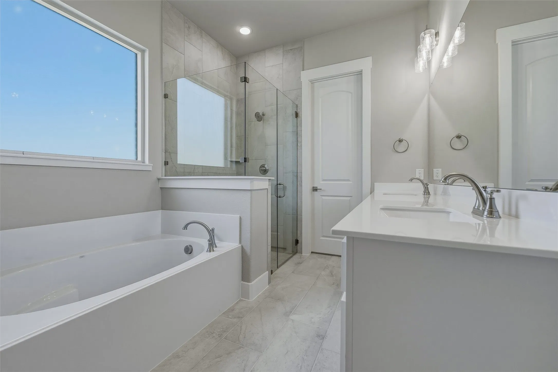 Dual vanity with quartz countertops, integrated sinks, and brushed nickel fixtures