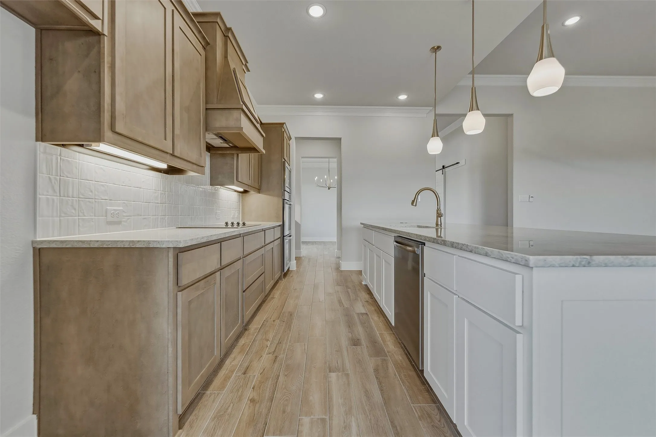 Wood-finish flooring, recessed lighting, and crown molding