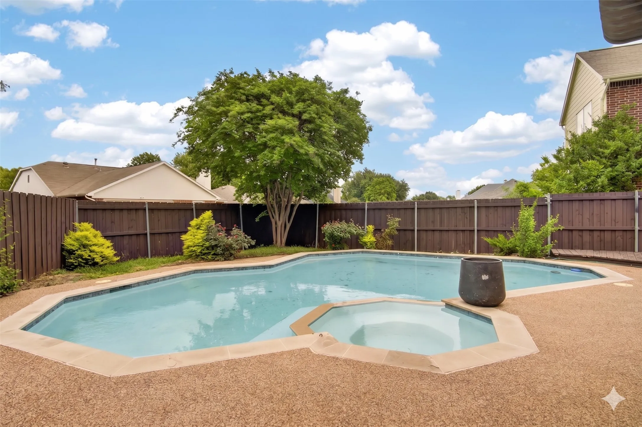 The property features a private backyard with a large swimming pool and an integrated spa