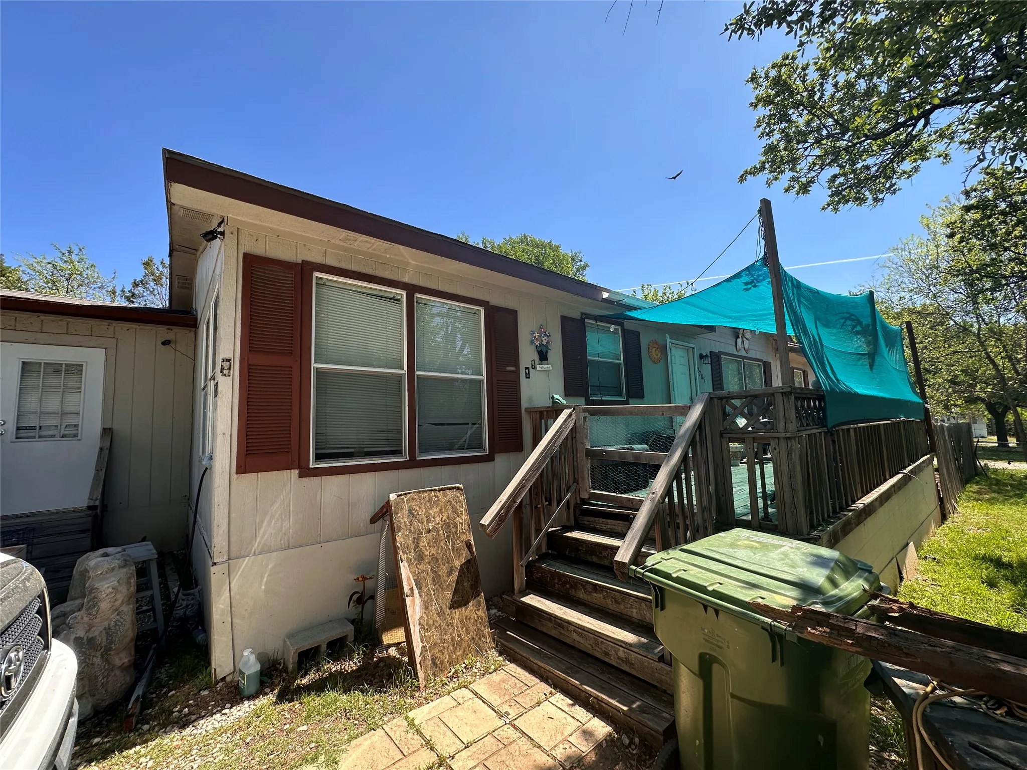 Exterior siding with brown window shutters