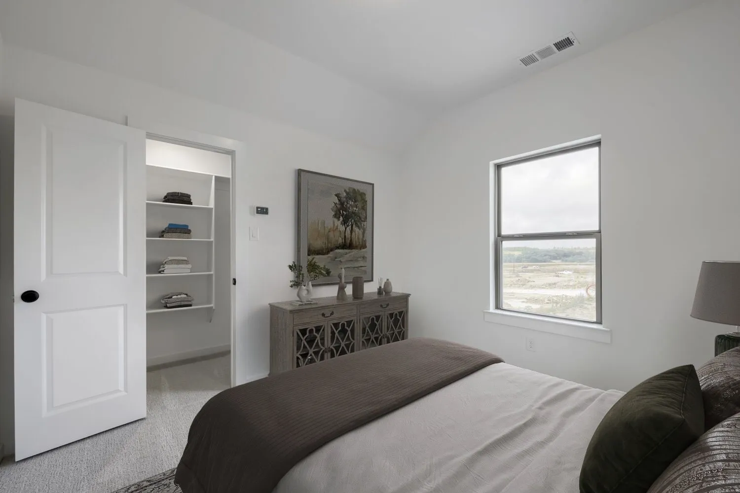 VIRTUALLY STAGED PHOTO Bedroom featuring a single window, white walls, and light-toned carpet
