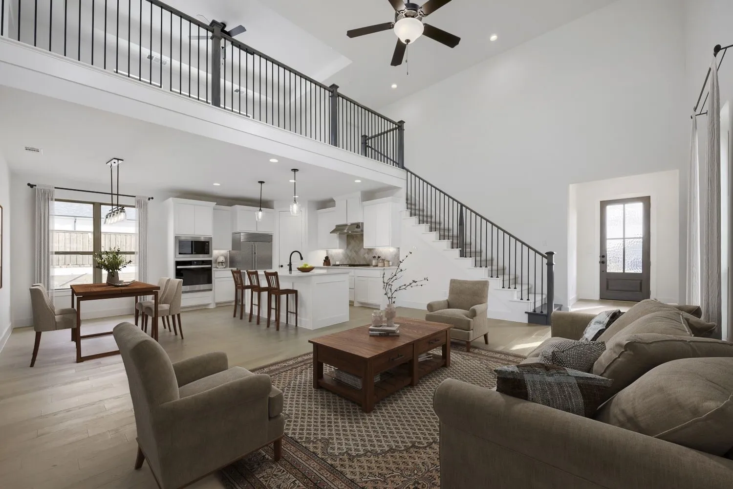 VIRTUALLY STAGED PHOTO Two-story living area with high ceilings, an open-concept kitchen, and a loft space