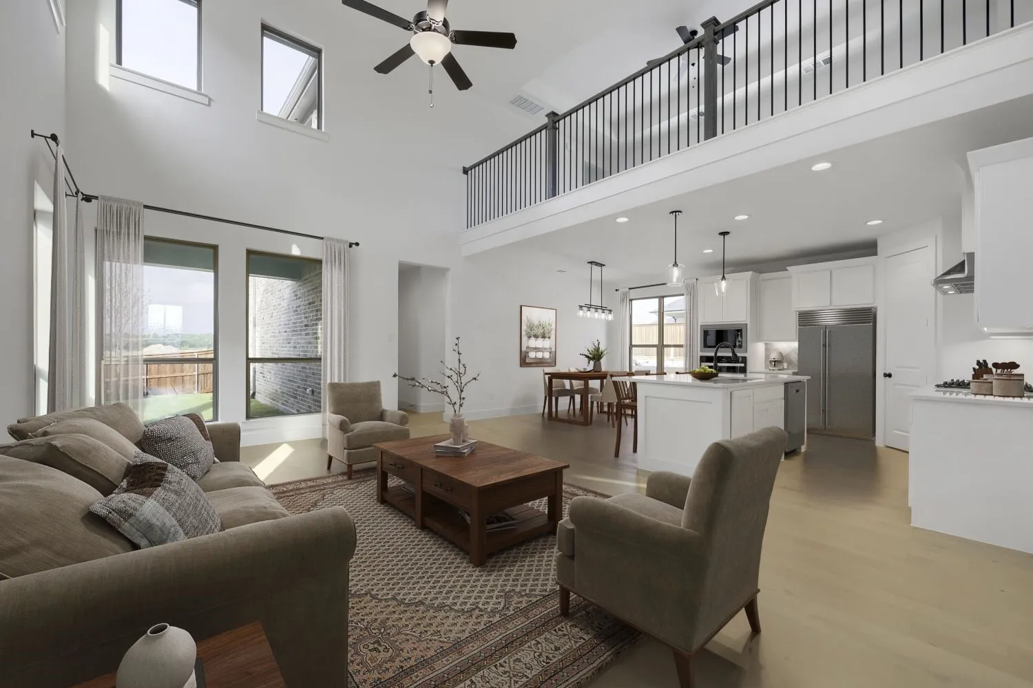 VIRTUALLY STAGED PHOTO Open-concept living area featuring high ceilings, wood-finish flooring, a kitchen island with pendant lighting, and a second-story balcony with metal railing