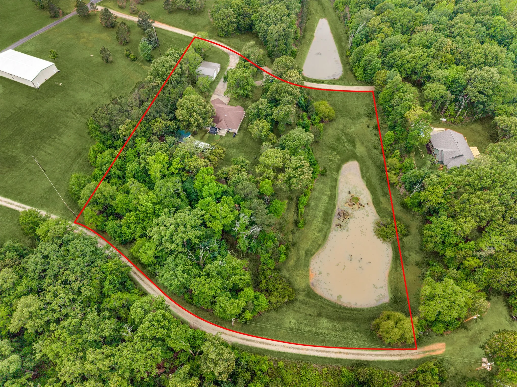 Aerial View of the property. The depth of the pond fluctuates based on weather and time of year. These are approximate boundry lines.