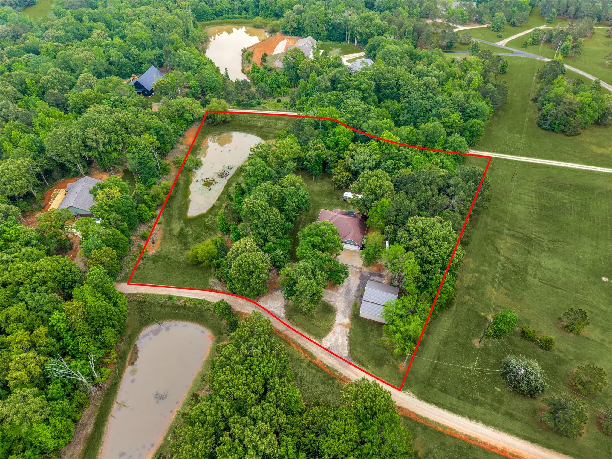 2.95 Acres which includes the pond that is stocked with fish. A small portion of the ponds shoreline is shared with the neighbor. These are approximate Boundry Lines.